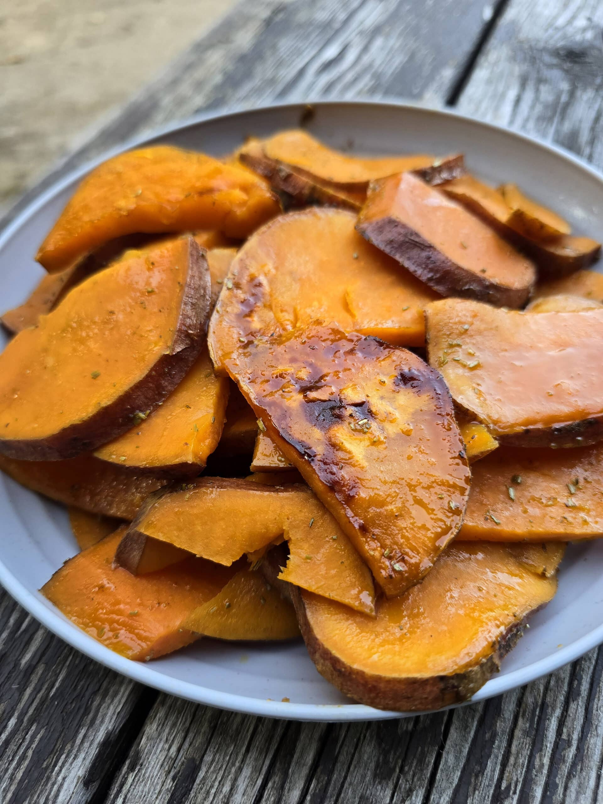 A plate of rosemary maple sweet potato slices.