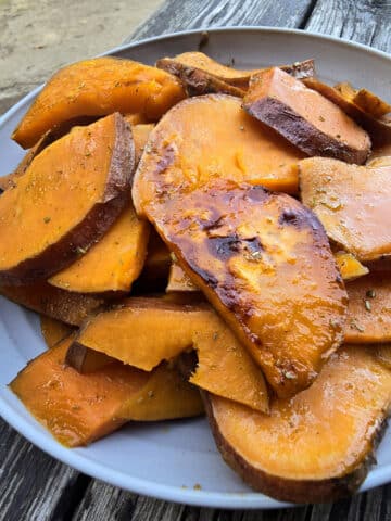 A plate of rosemary maple sweet potato slices.