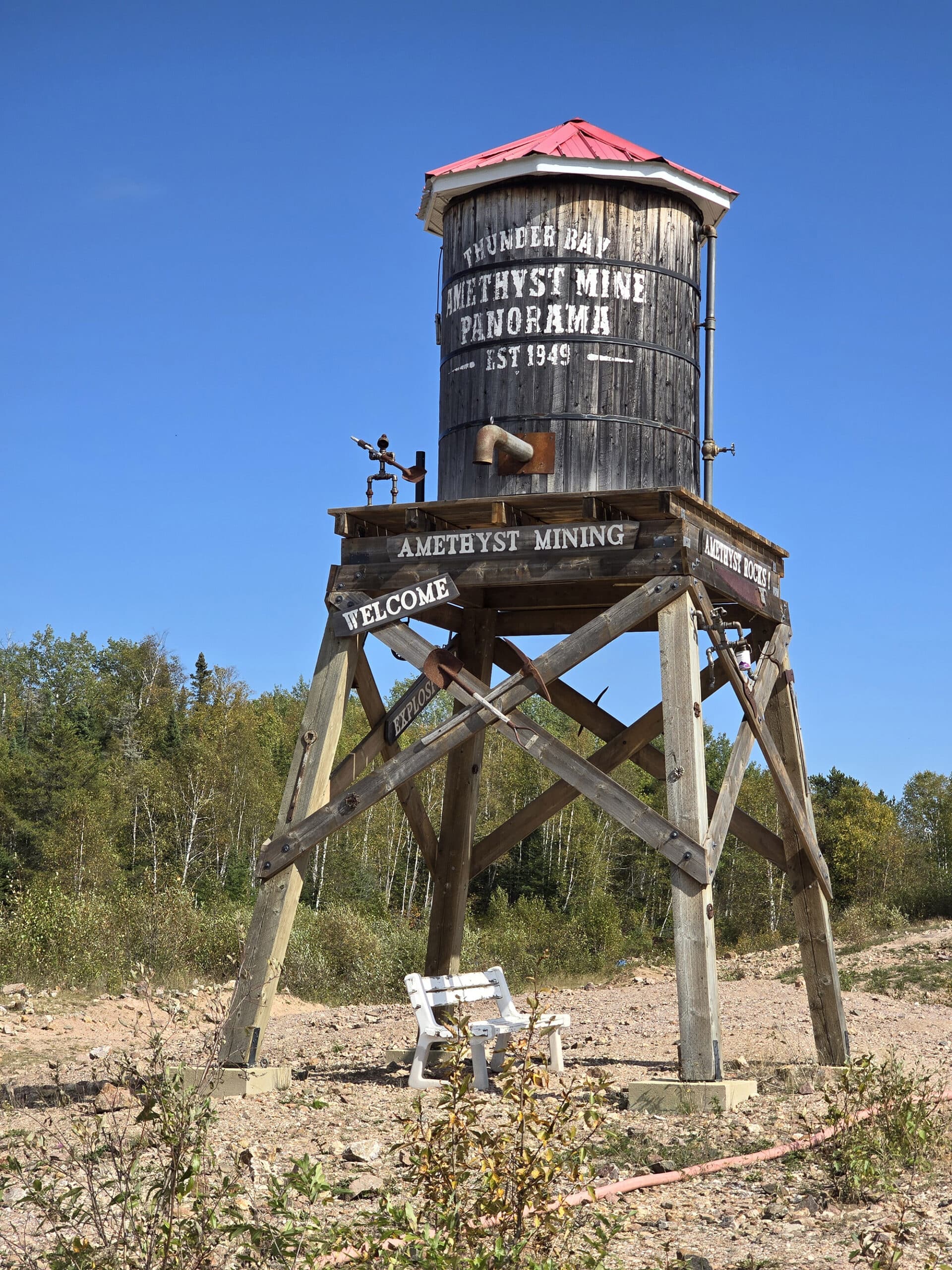 A small water tower with amethyst mine panorama printed on it.