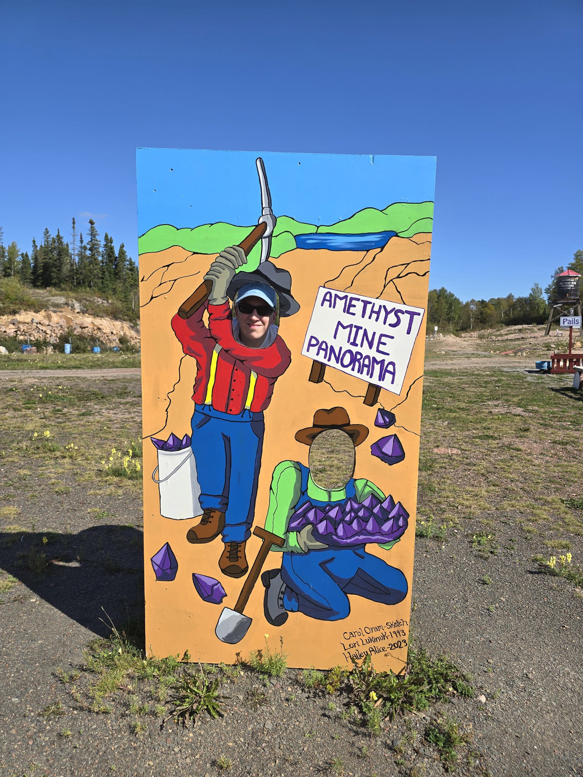 A tourist photo opp board with amethyst prospectors painted on.