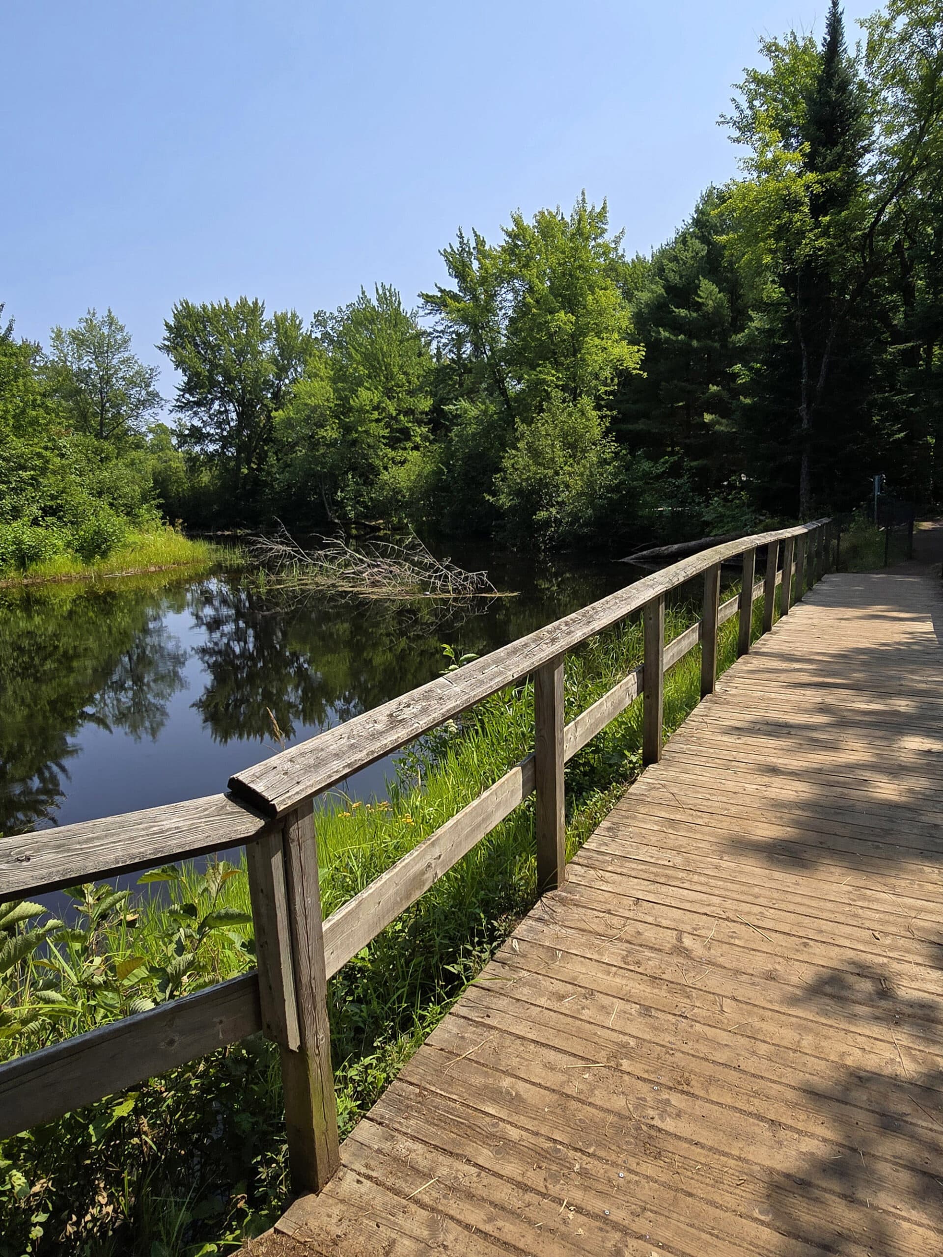 A wooden foot bridge crossing the Bonnechere river.