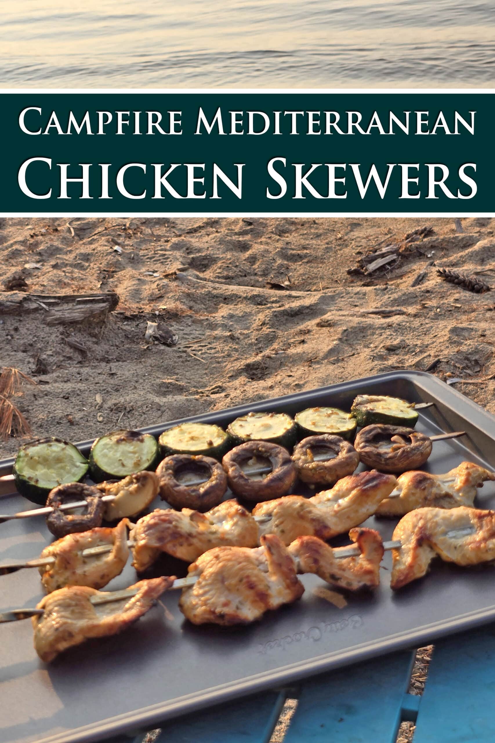 Mediterranean Chicken, mushroom, and zucchini kebabs on a tray with a beach behind it.