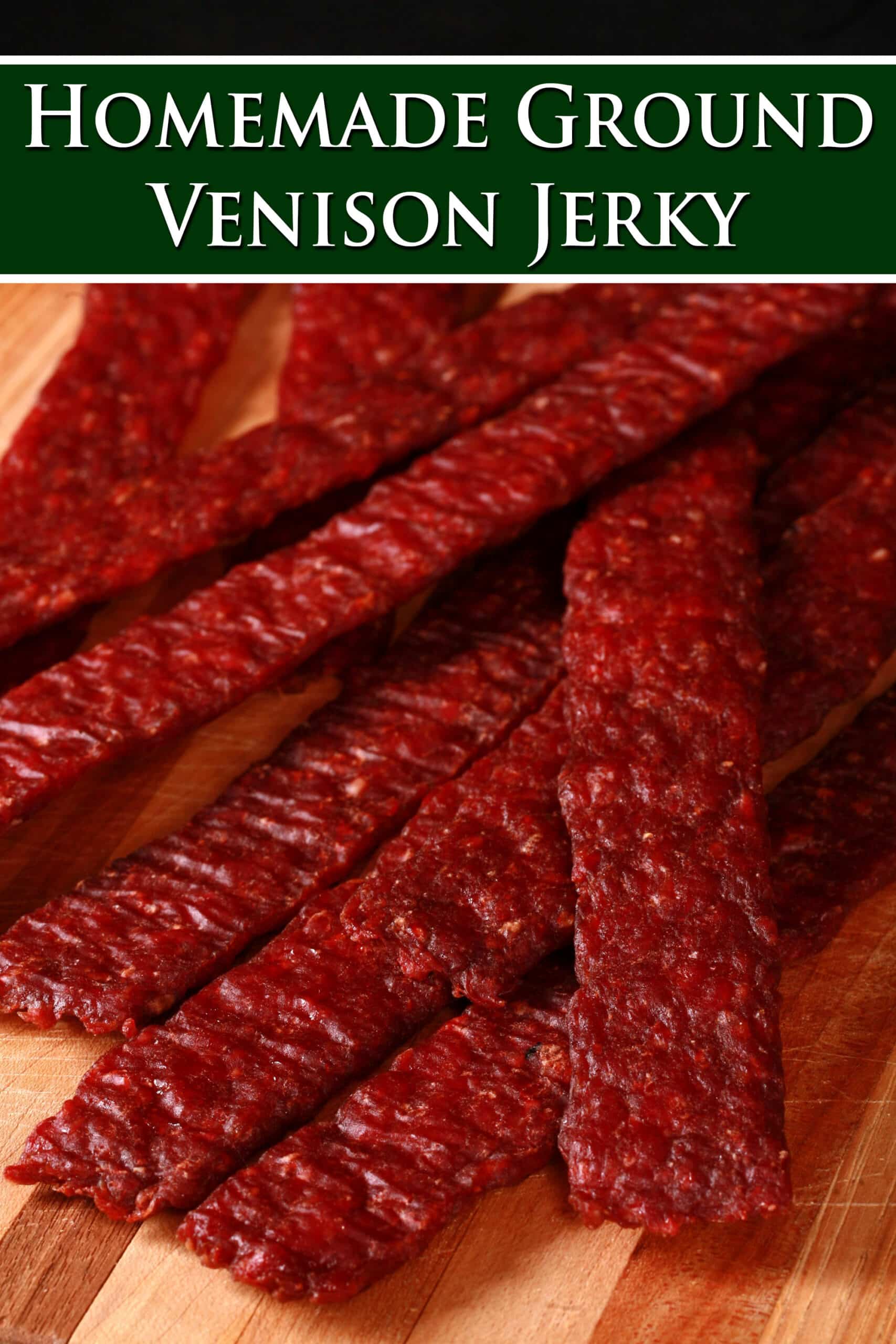 A pile of homemade venison jerky strips on a cutting board. Overlaid text says homemade ground venison jerky.