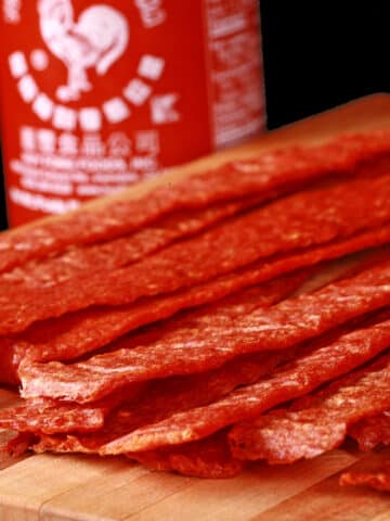 A pile of sriracha ground chicken jerky strips.