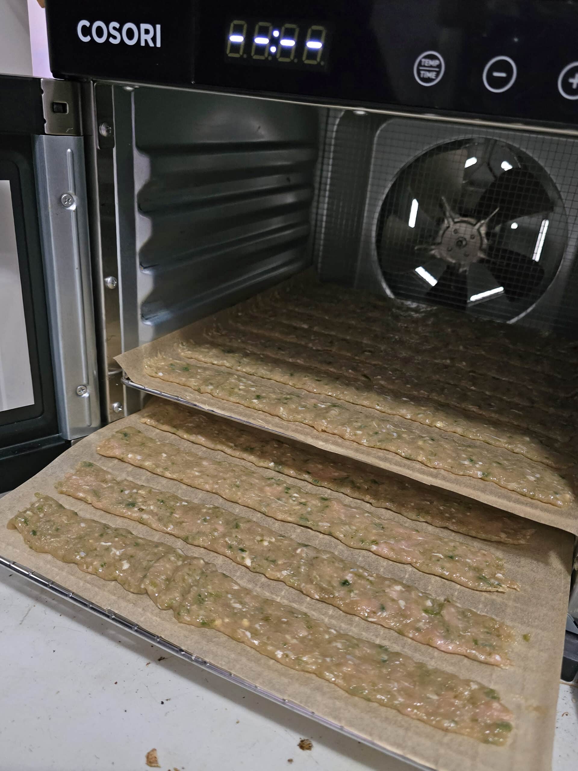 2 racks of jalapeno chicken jerky in a food dehydrator.