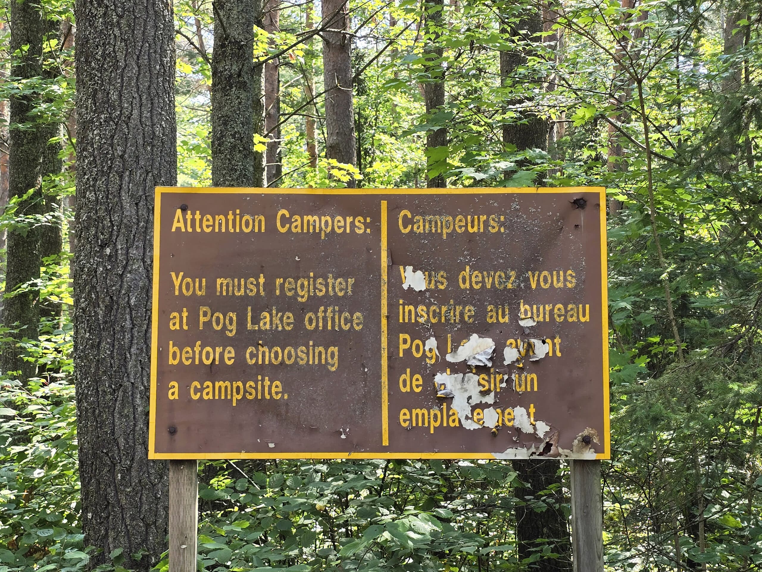 A campground sign telling people to register at Pog Lake.