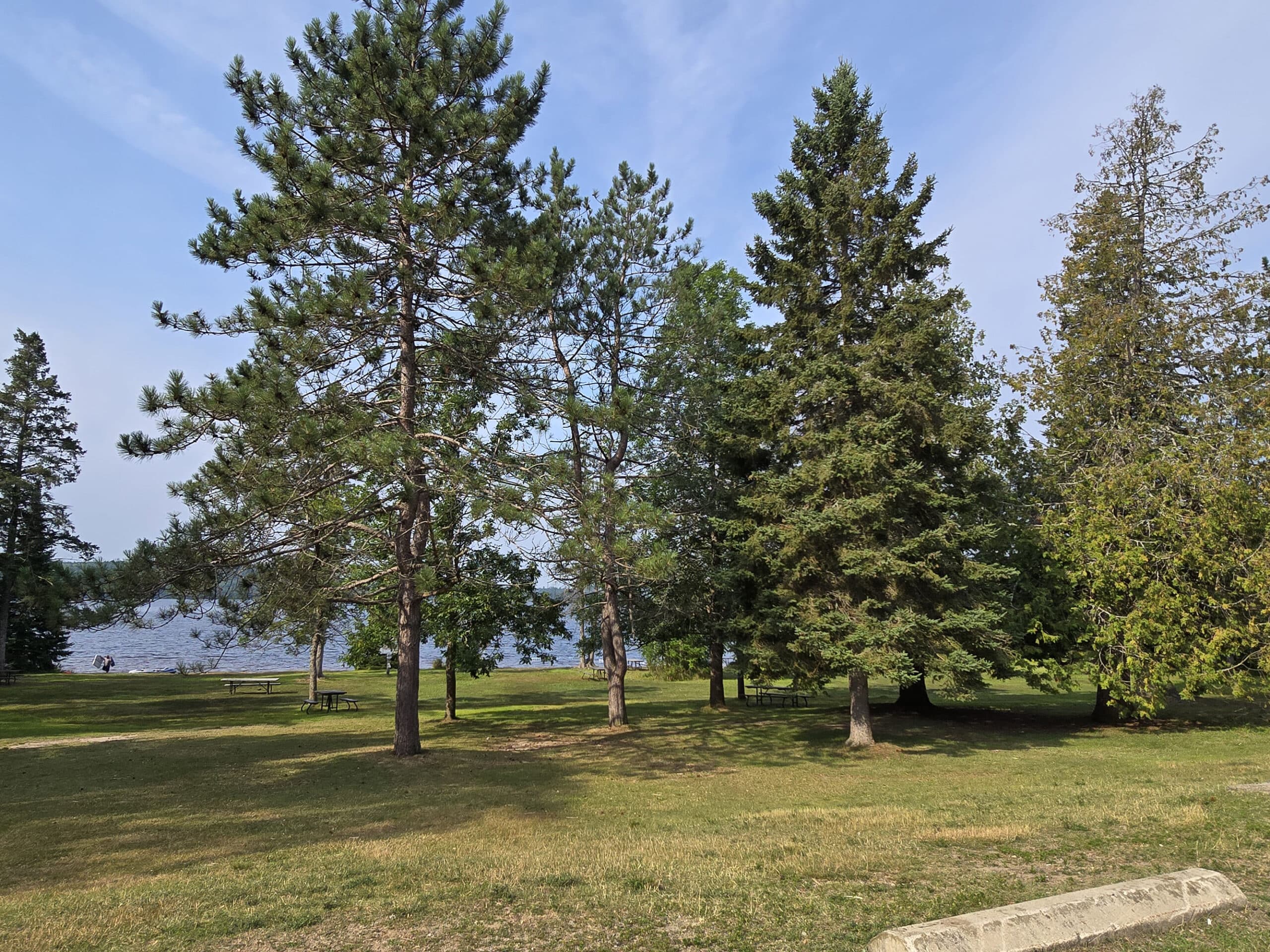 A wide picnic and day use area on the shore of Lake of Two Rivers.