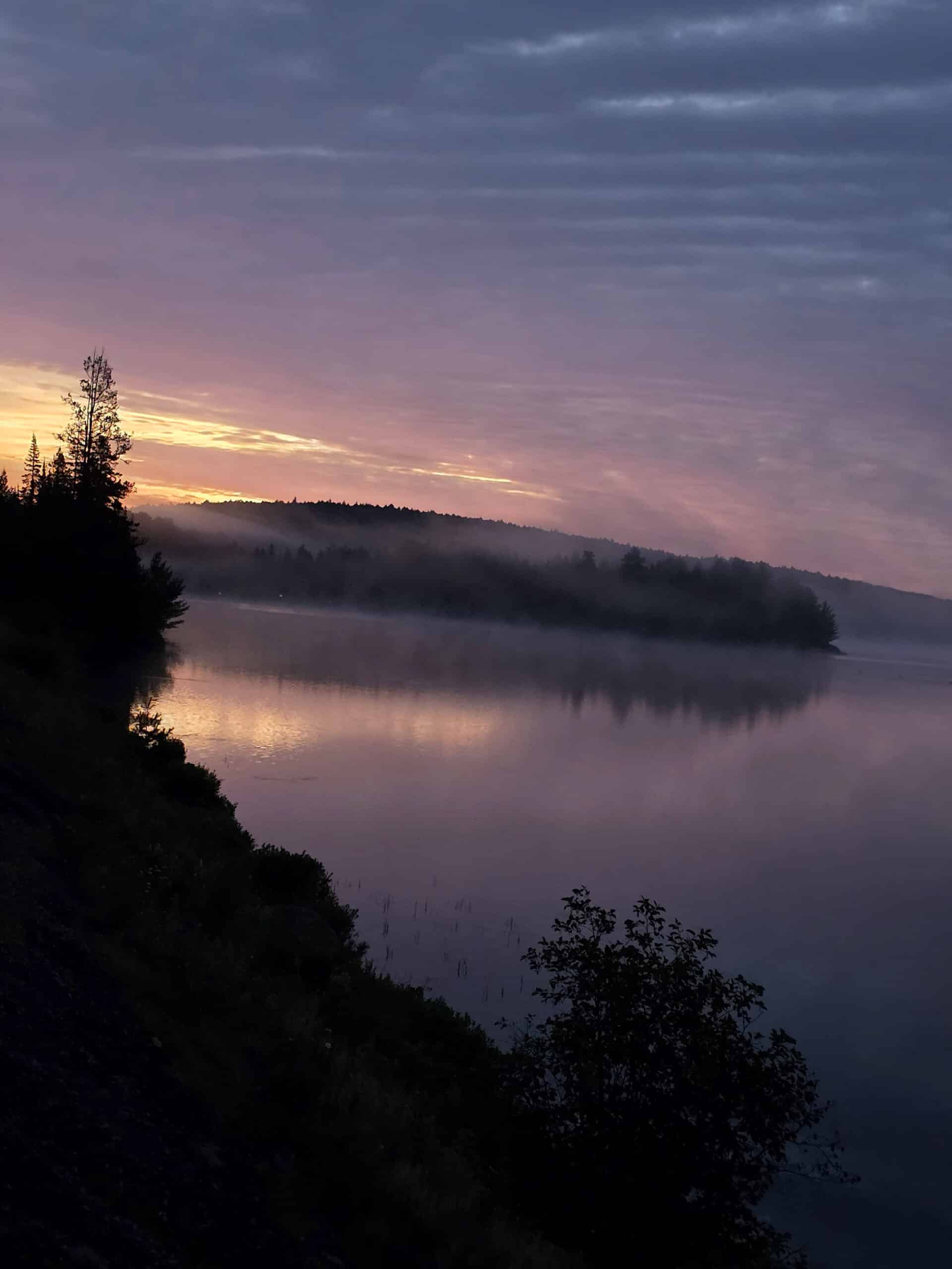 A misty island on lake of two rivers, at sunrise.