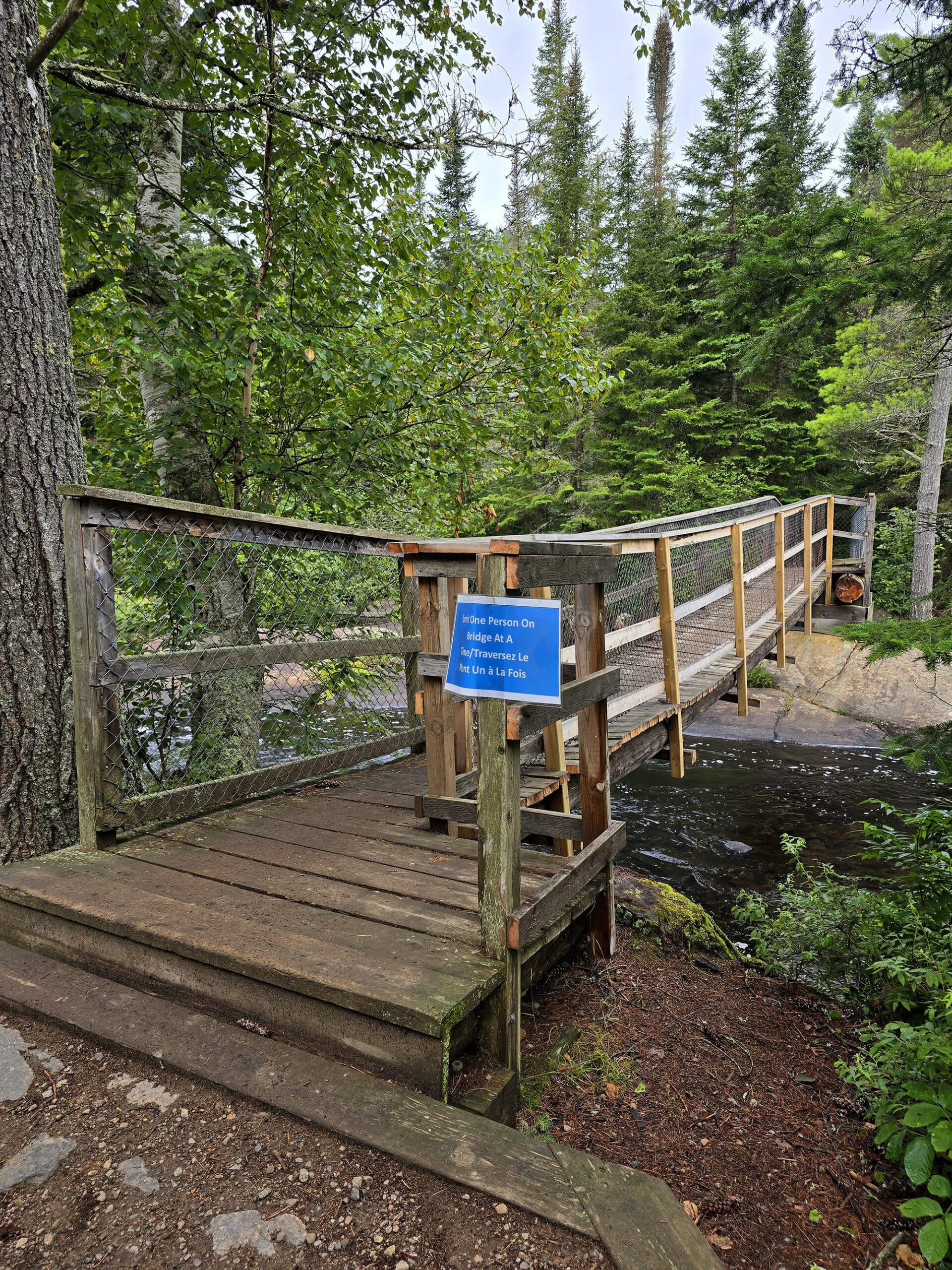 A wonky wooden bridge over the Madawaska River.