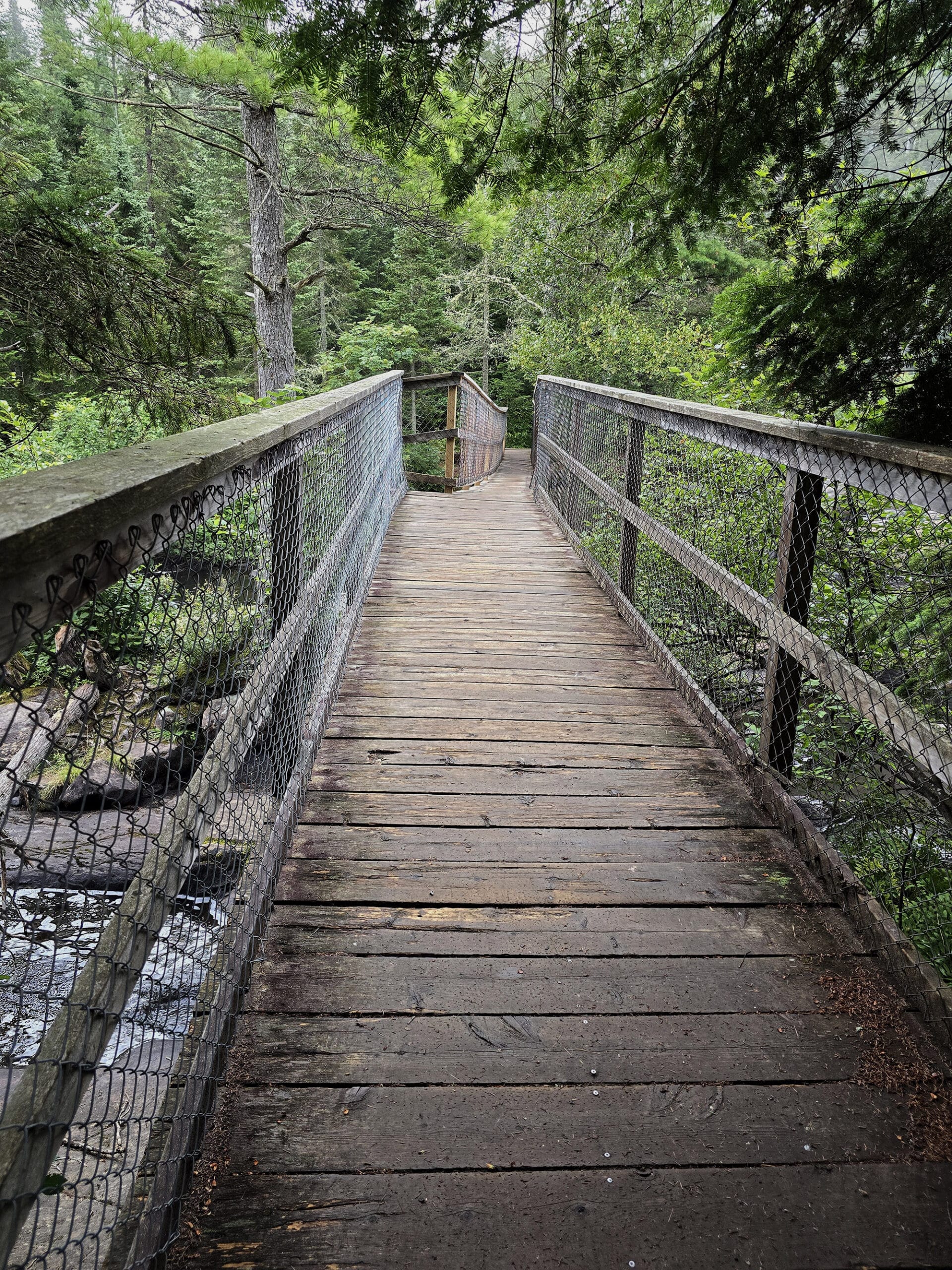 A wonky wooden bridge over the Madawaska River.