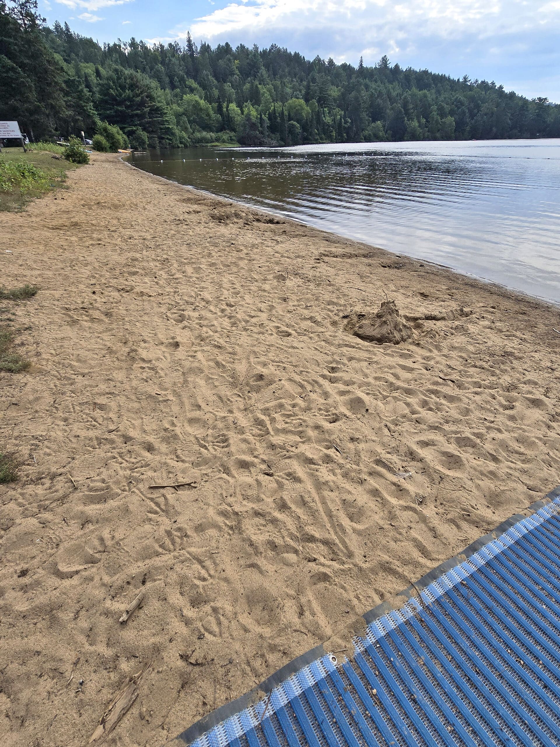 A long sandy beach on rock lake.