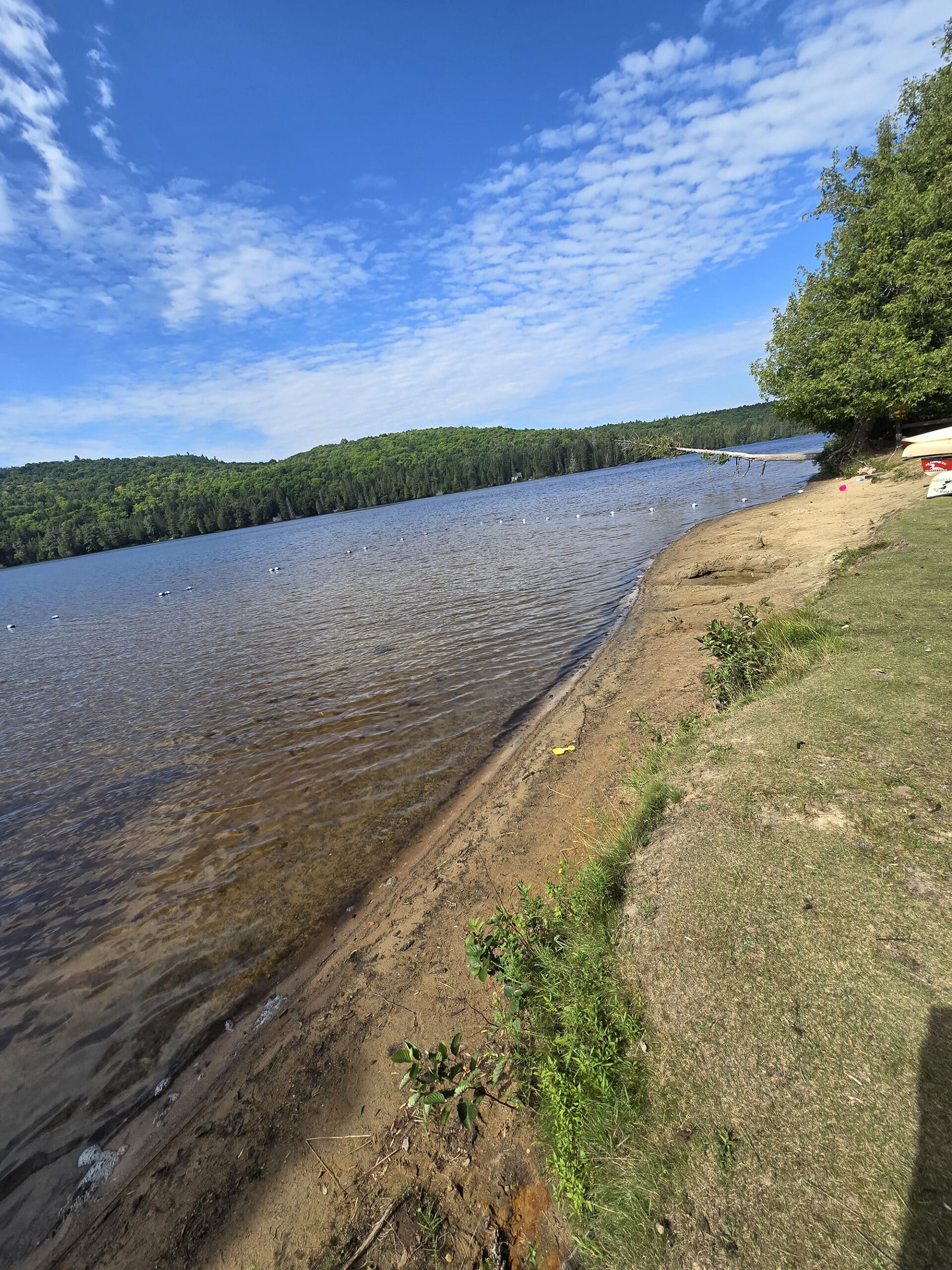 A long sandy beach on rock lake.