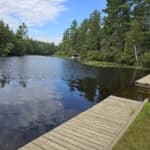 A boardwalk alongside rock lake.