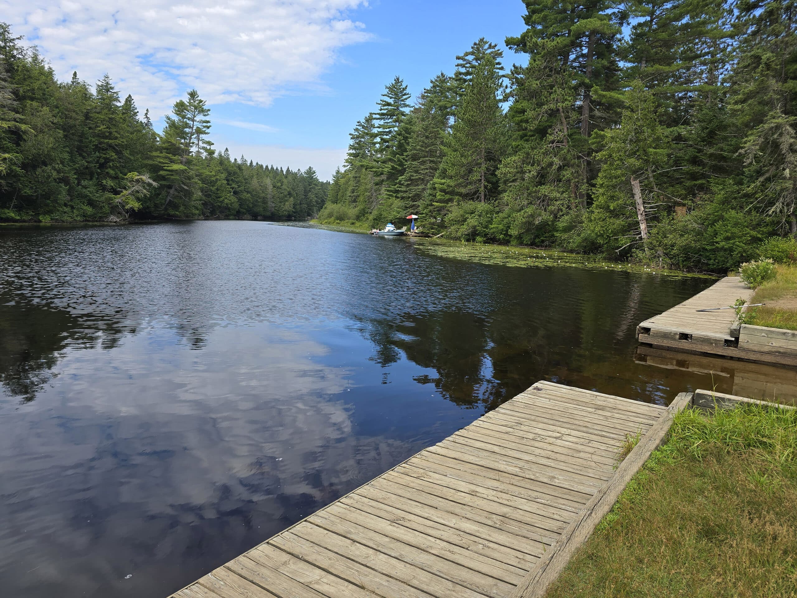 A boardwalk alongside rock lake.