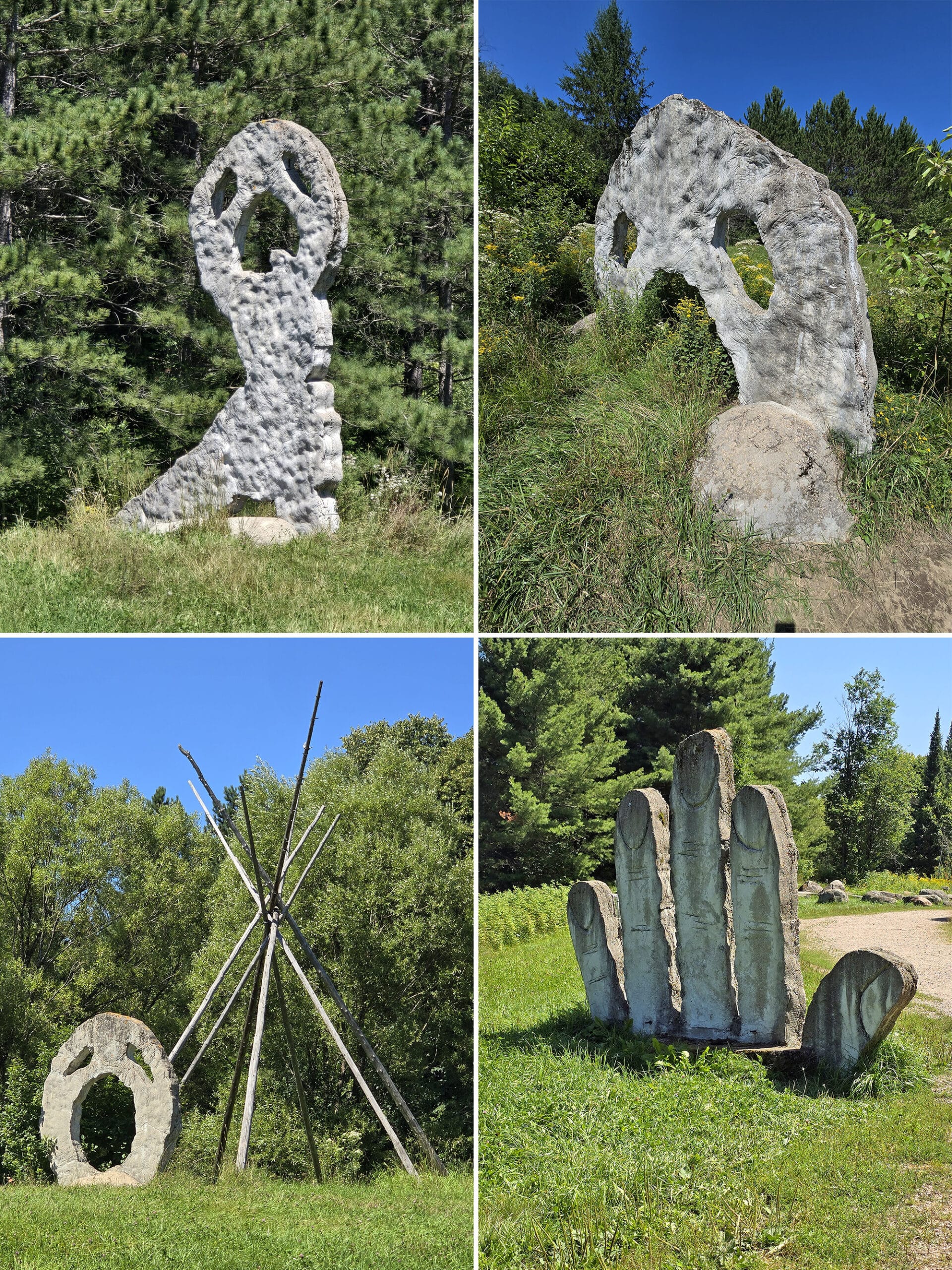 A grassy area with several 18 foot tall concrete sculptures that look like screaming heads.