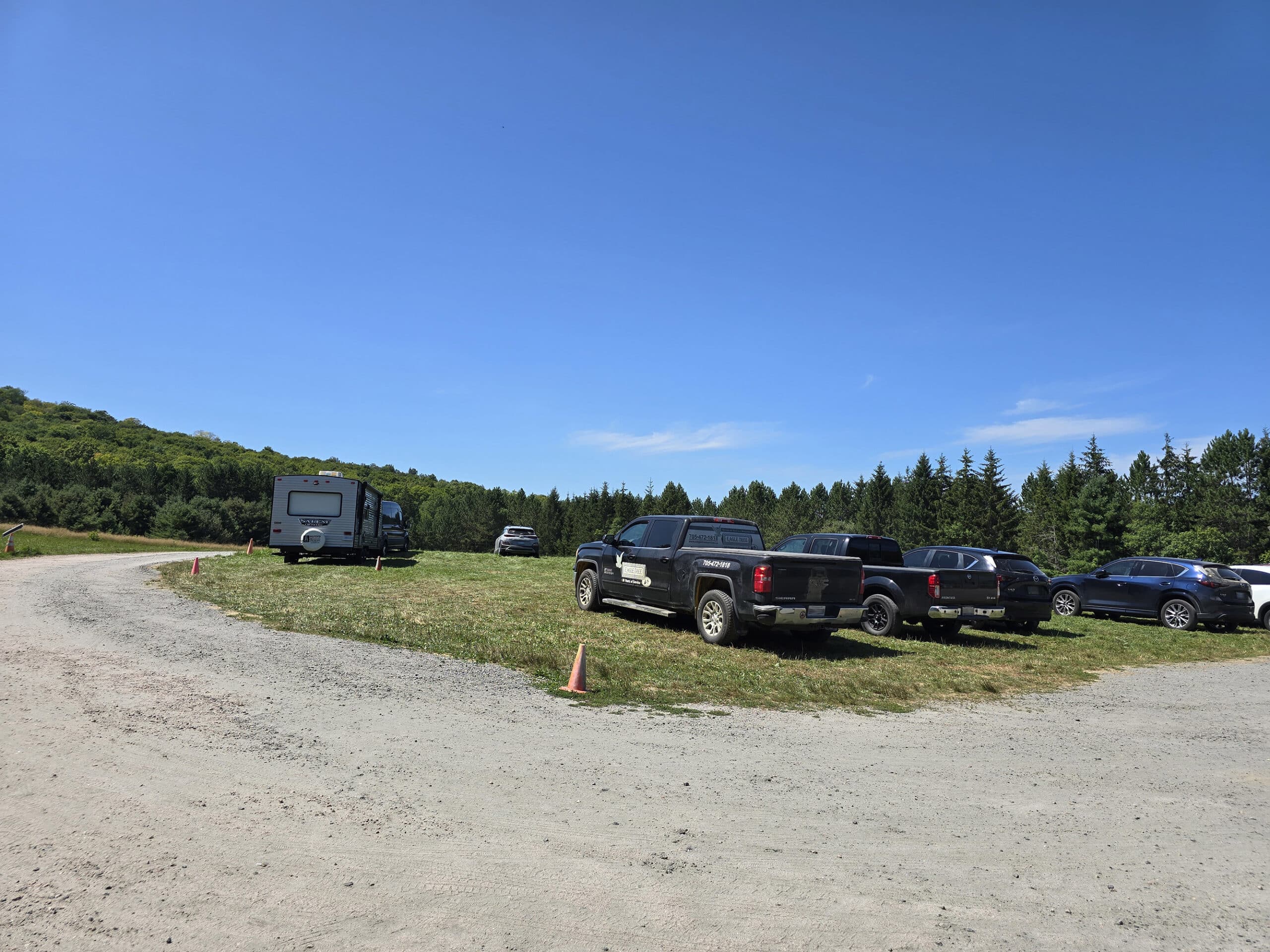 A large parking lot in a field.