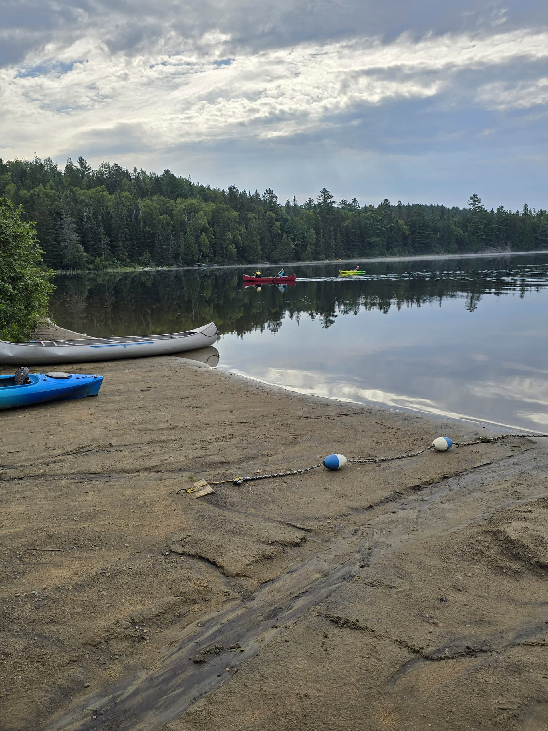 Two canoes on the shore of whitefish lake.