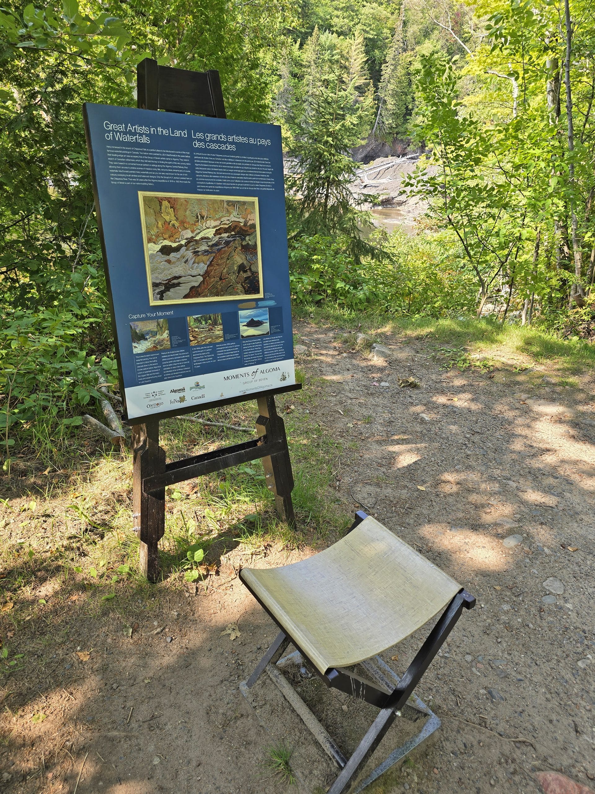 An easel and painter seat Moments of Algoma display.