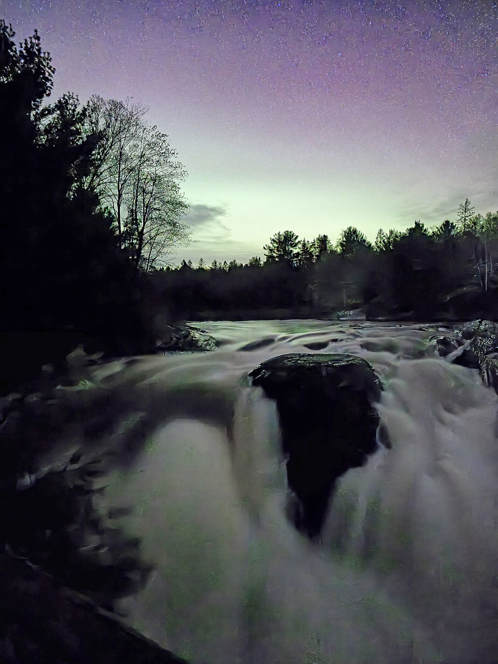 Northern lights over a waterfall at Chutes Provincial Park