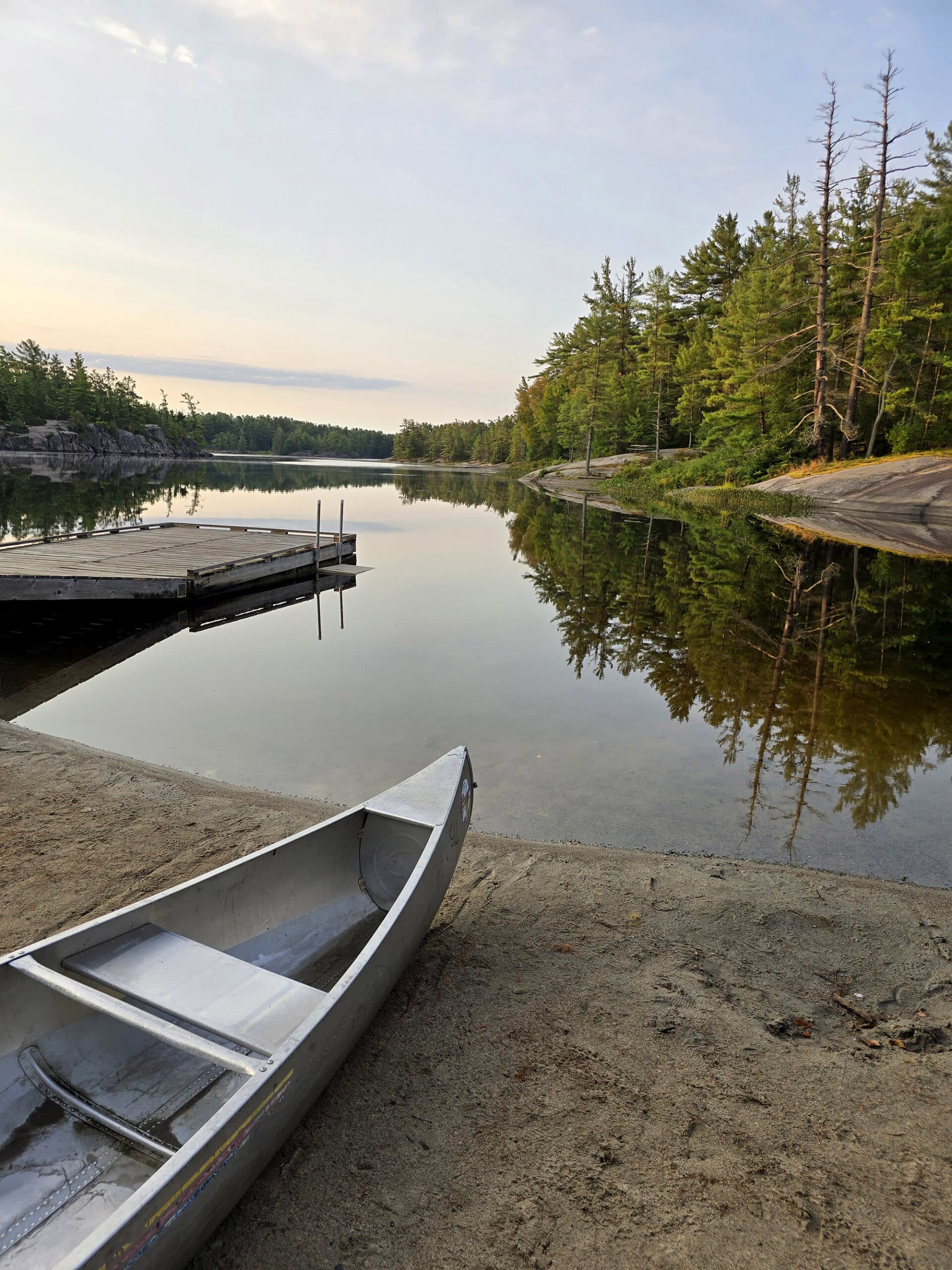 A wooden boat dock and beach on Gut Lake in Grundy Lake Provincial Park