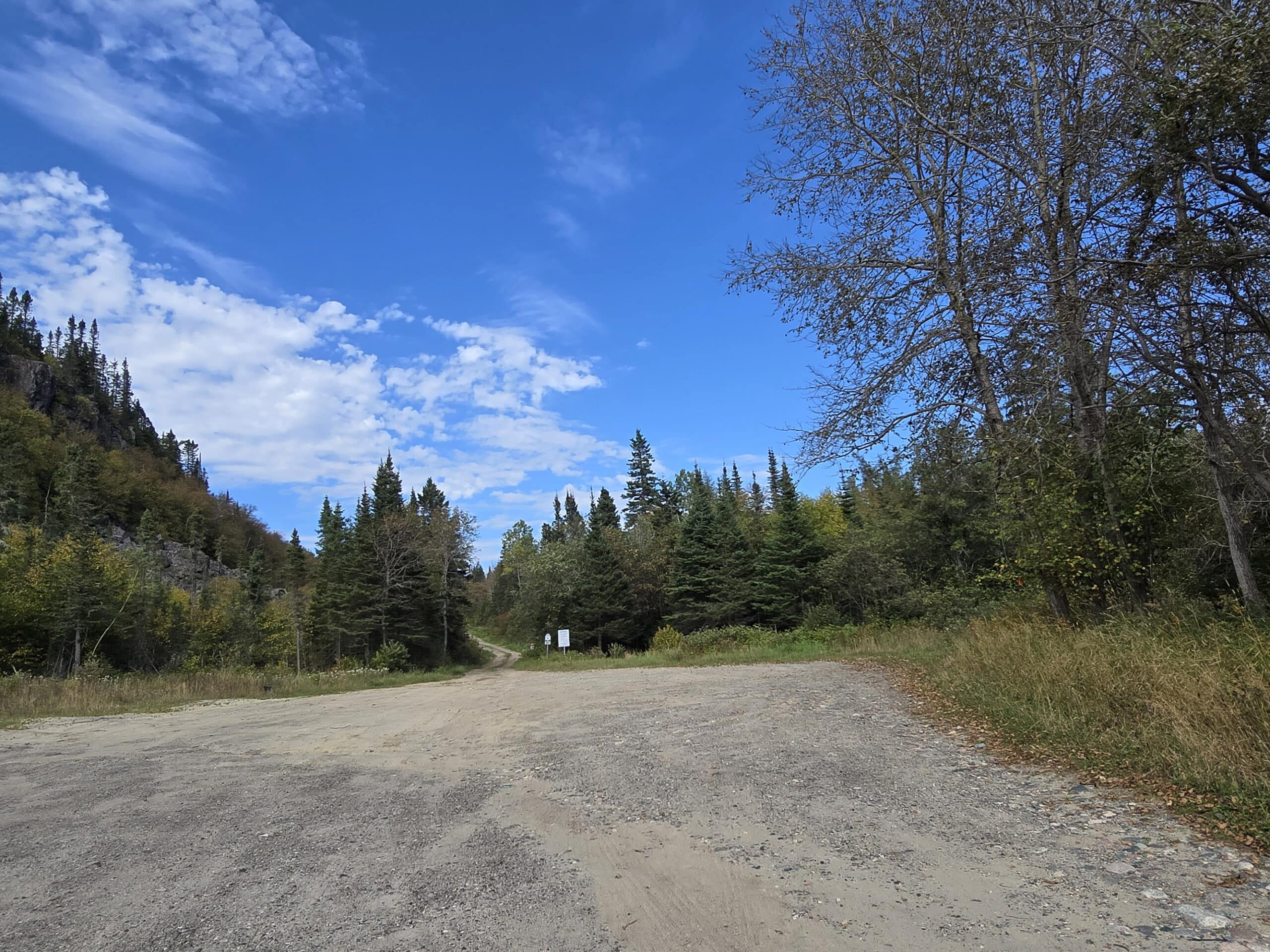 A wide gravel parking lot.