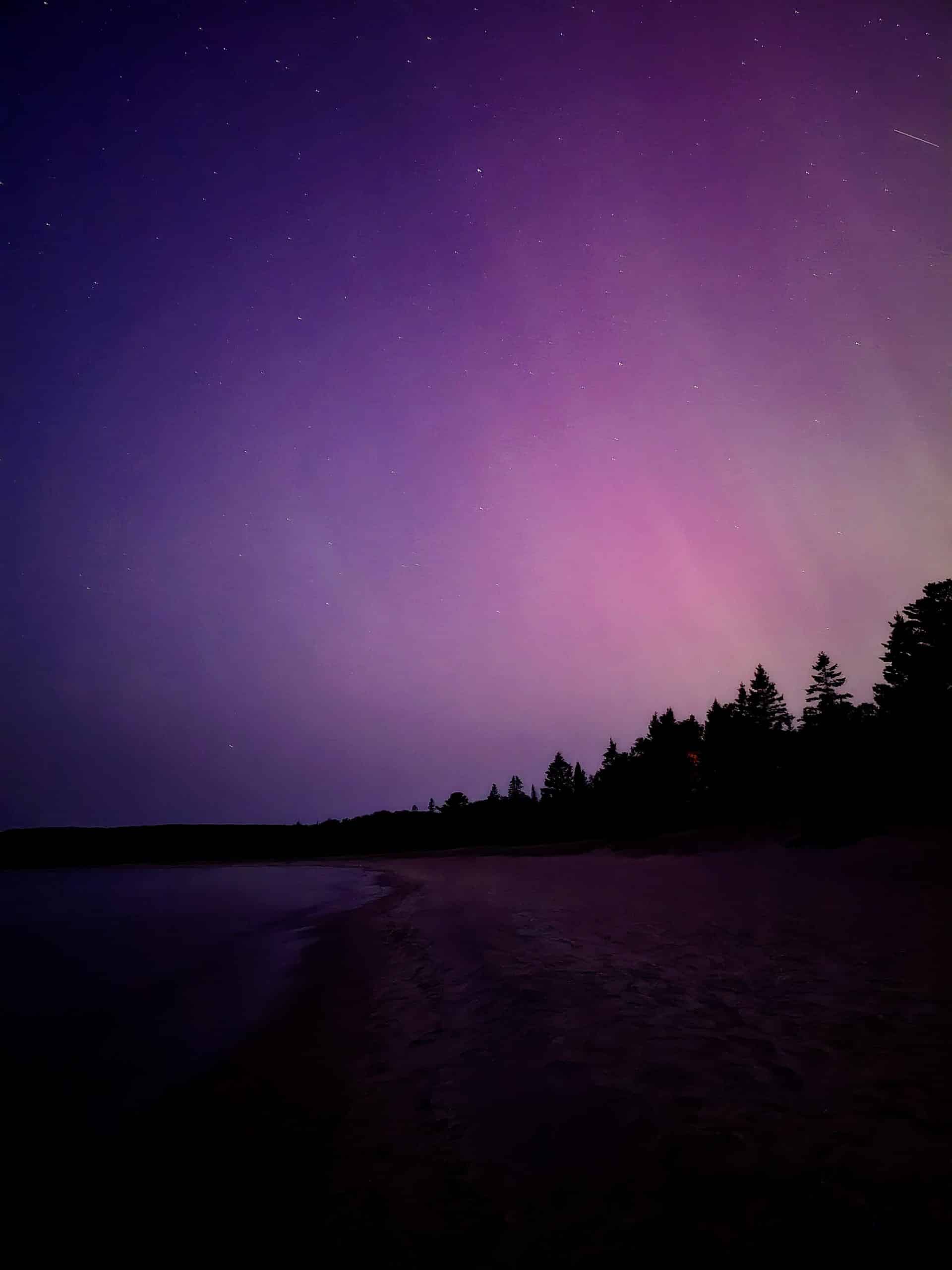 The aurora borealis over pancake bay provincial park.