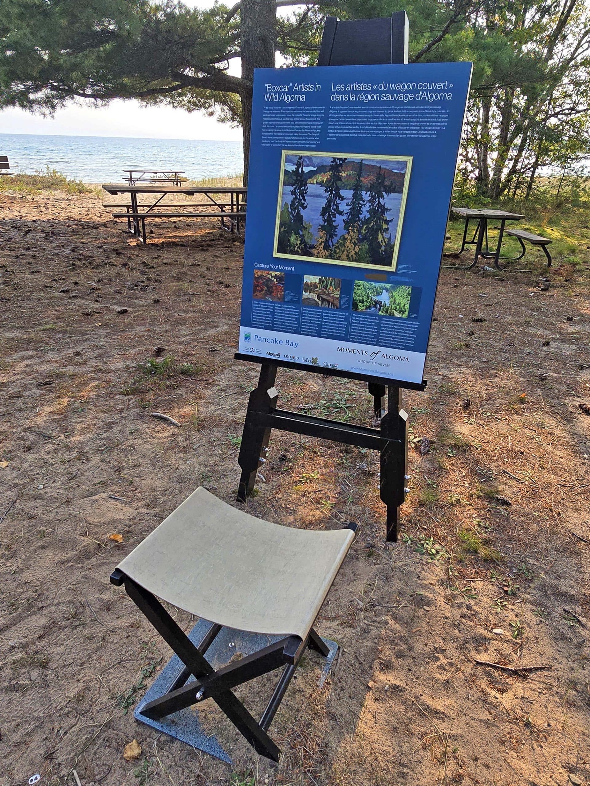 An easel and seat with moments of algoma signage about the group of 7.