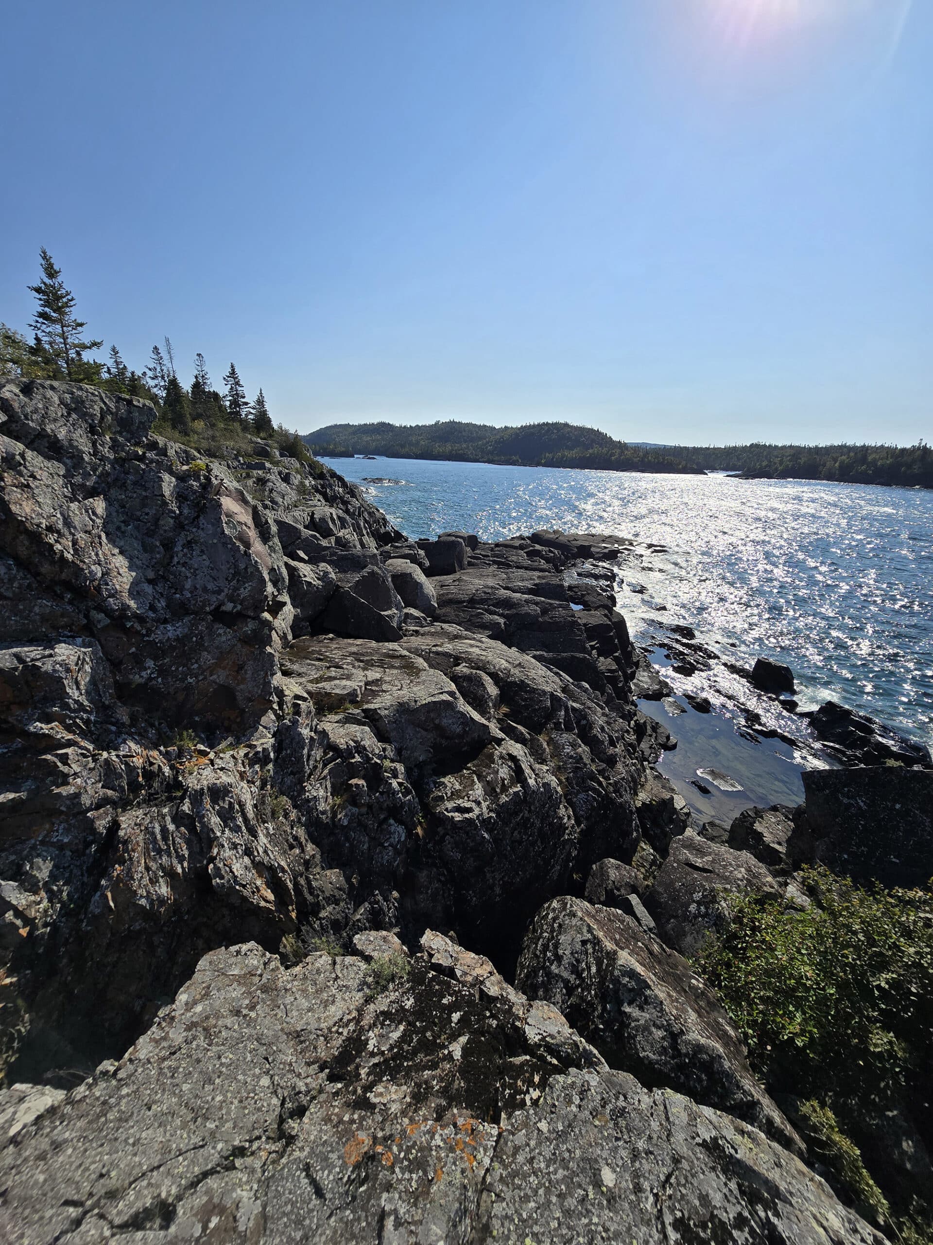 A view of lake superior, over a rocky ledge.