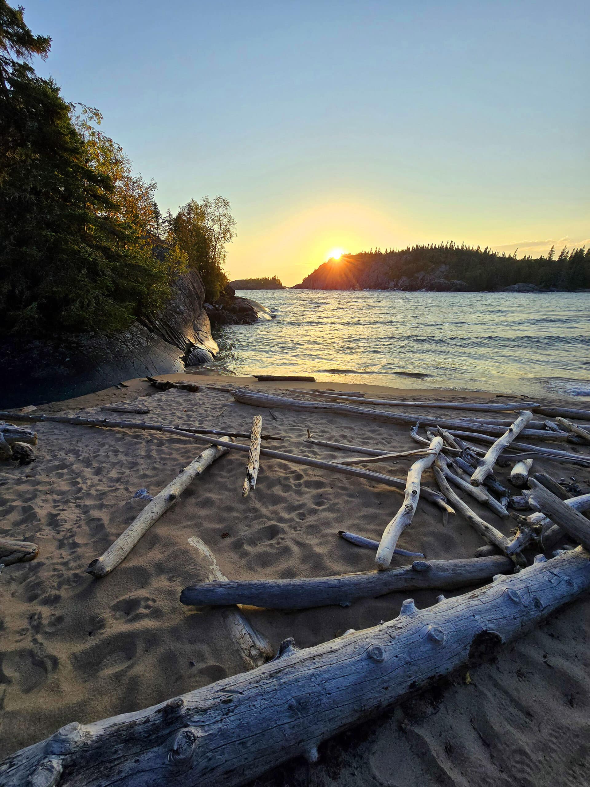 Driftwood on a lake superior beach at sunset.