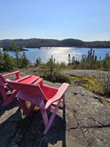 2 red chairs overlooking lake superior.