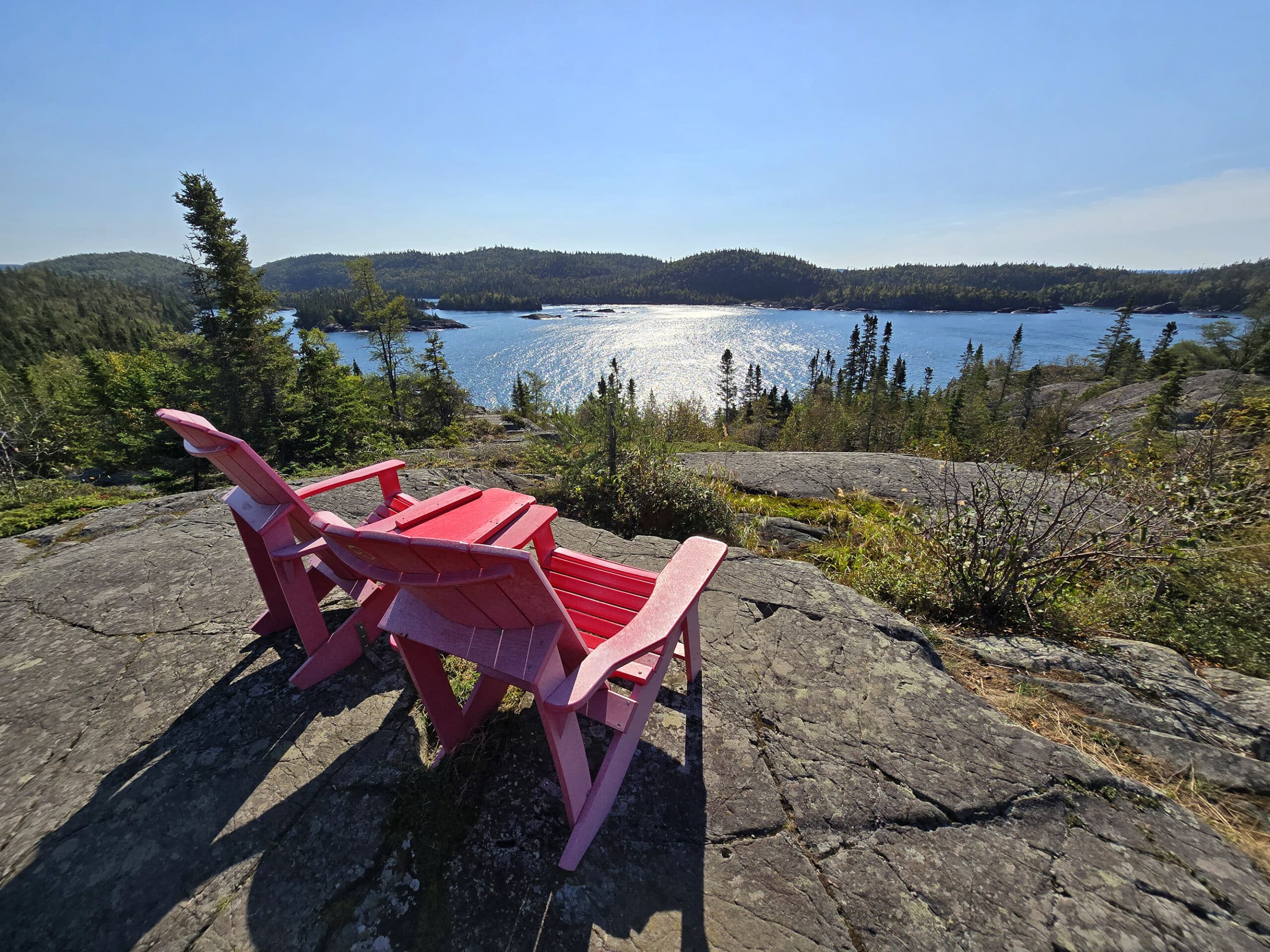 2 red chairs overlooking lake superior.