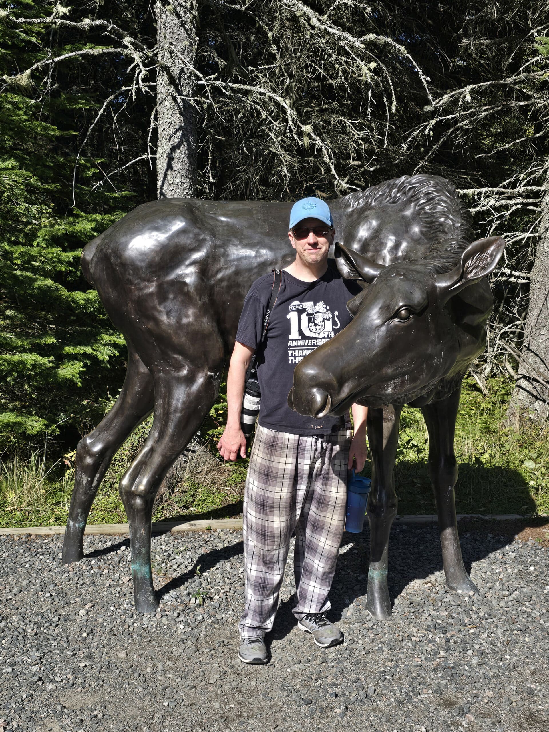 Michael Porter posing with a moose statue.