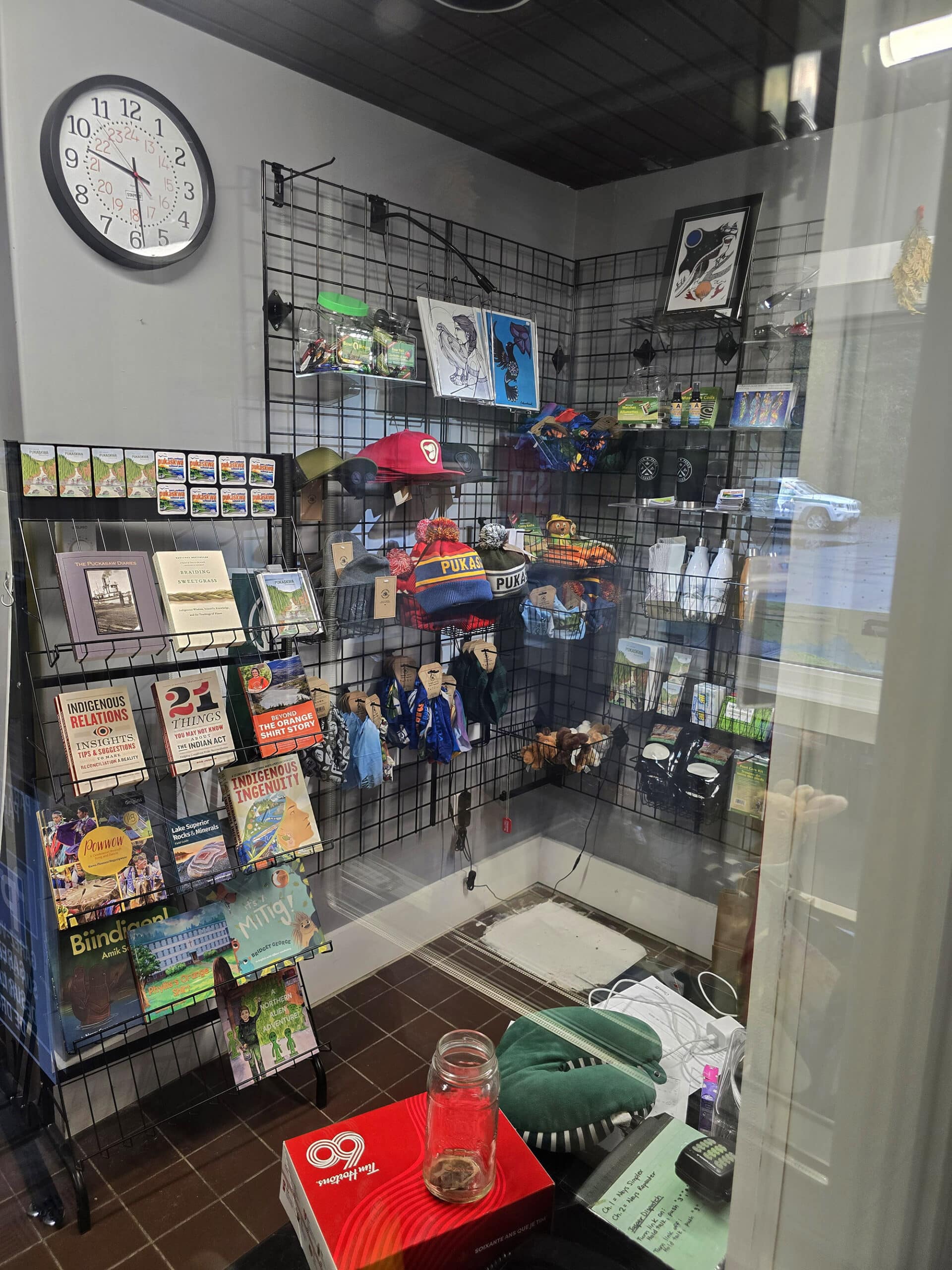 Several racks of souvenirs, photographed through a window.