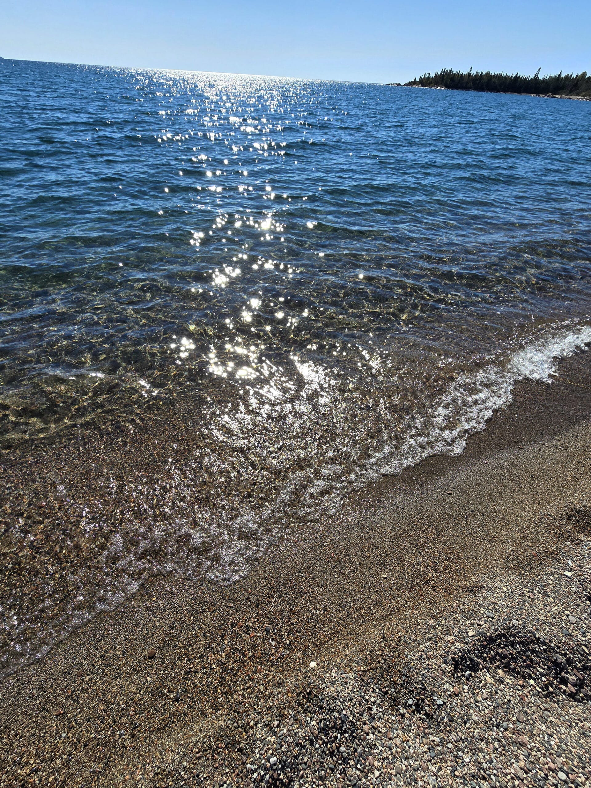 Crystal clear Lake superior water on a rocky beach.