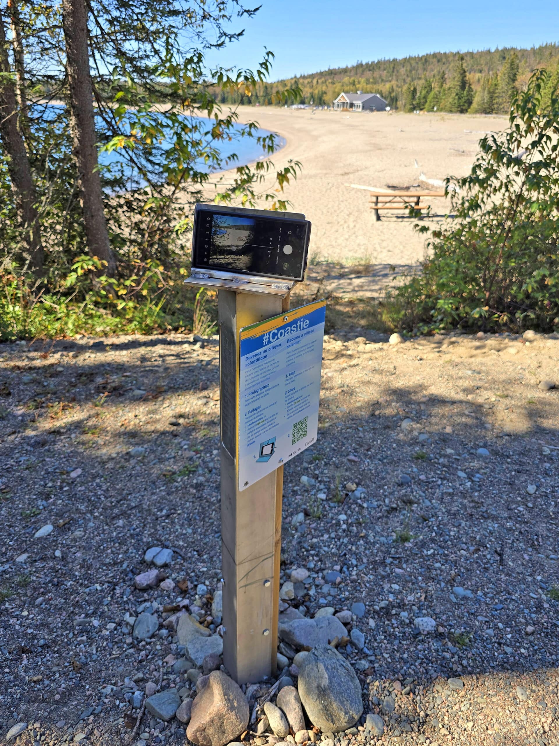 A coasties cell phone holder set up with instructional sign.