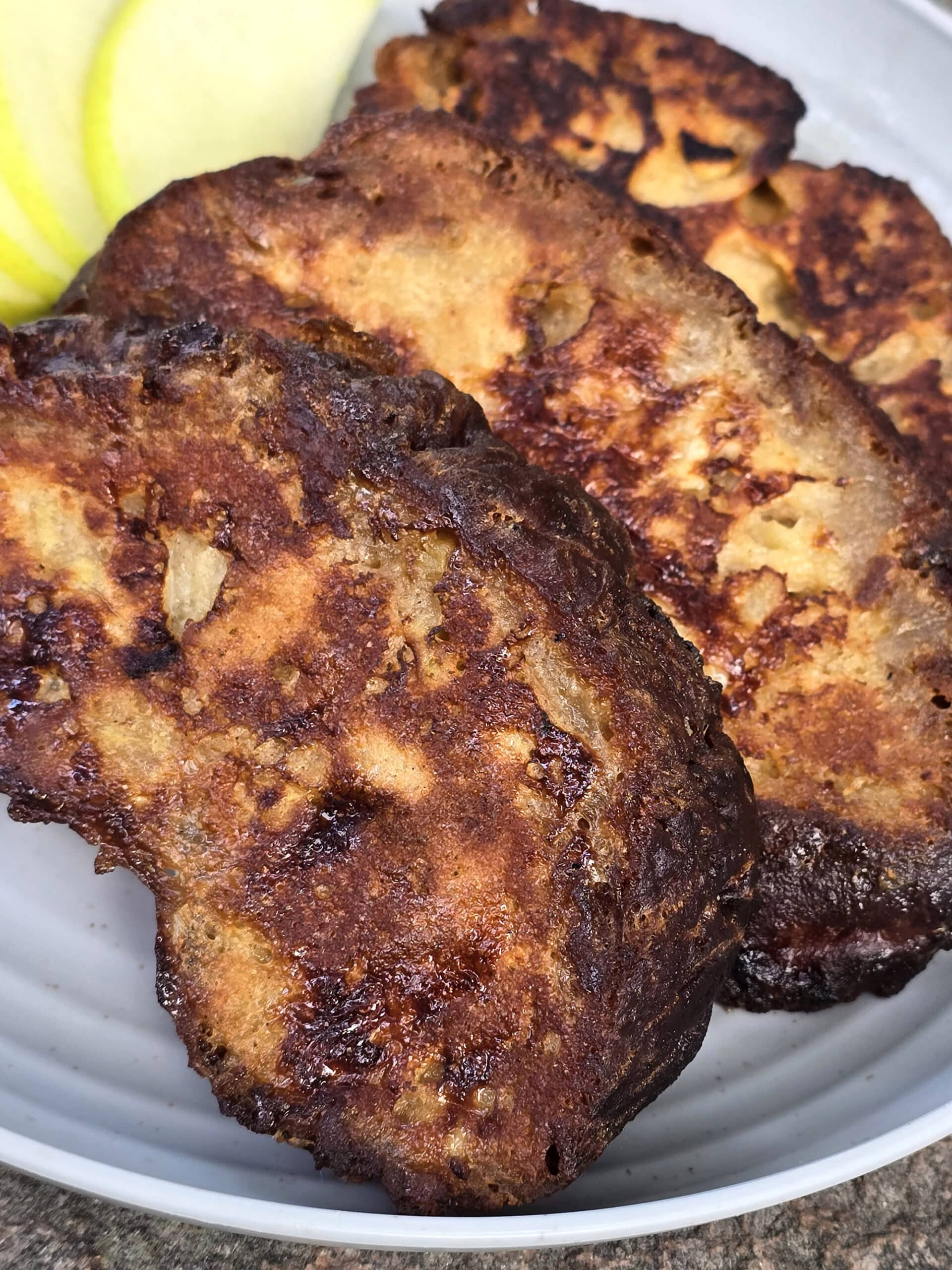 A plate of apple fritter french toast slices.