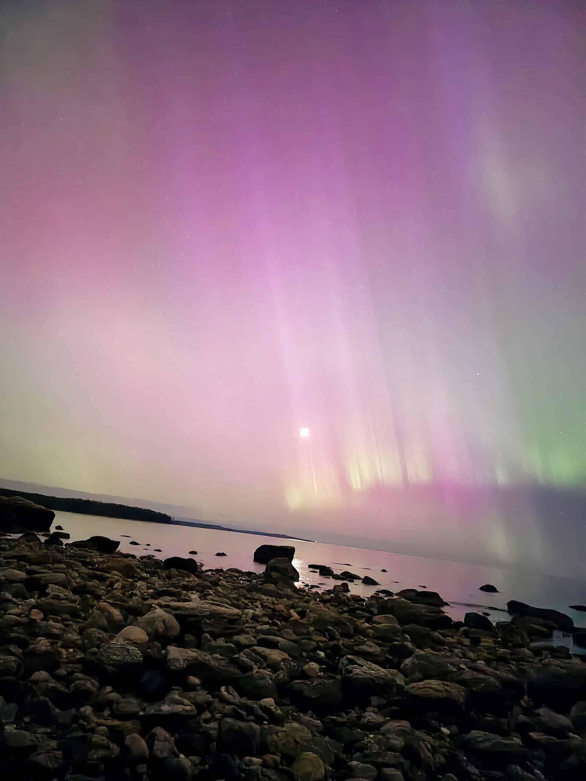 Bright pink aurora borealis display at awenda Provincial Park.