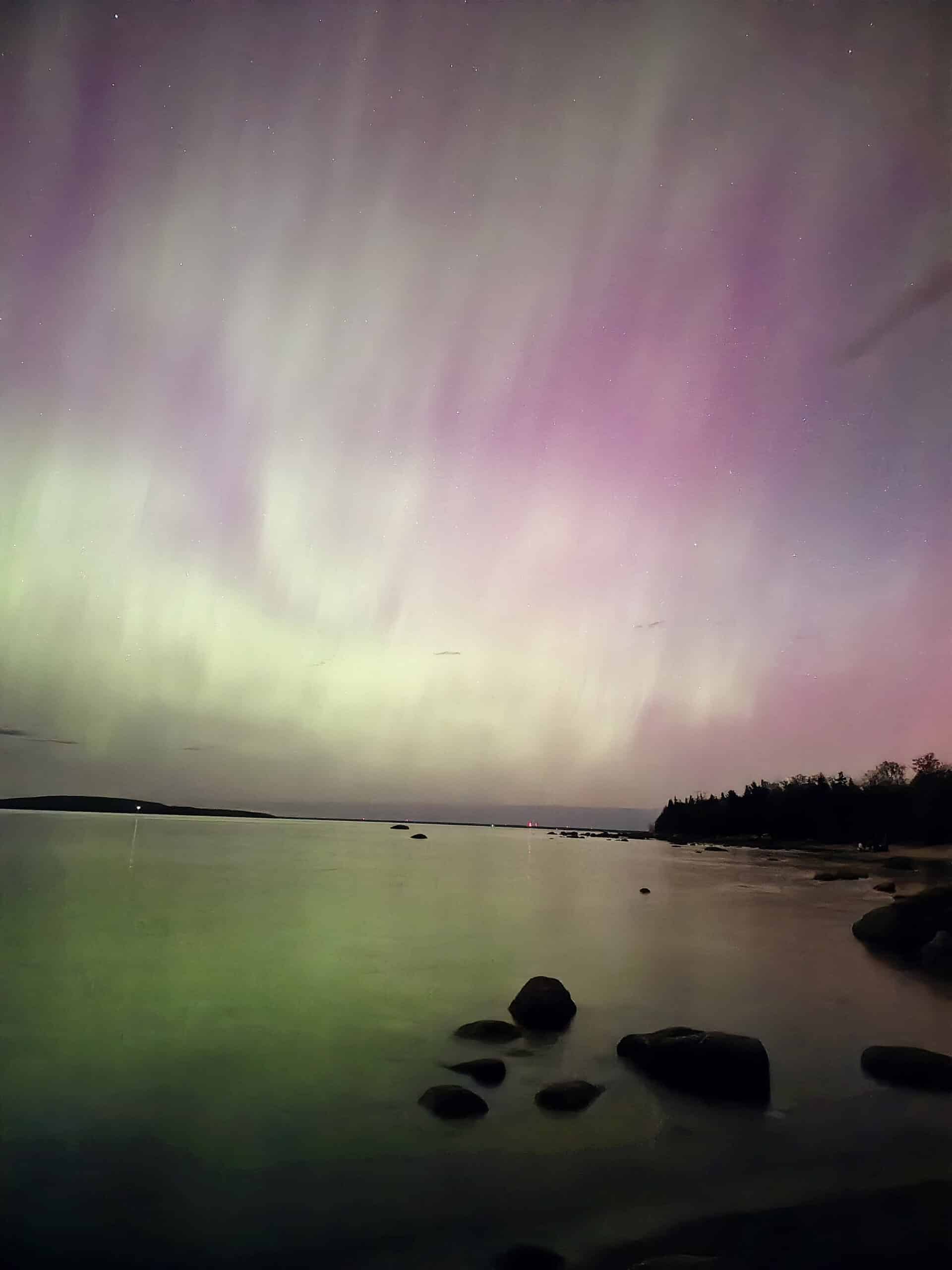 Bright pink aurora borealis display at awenda Provincial Park.