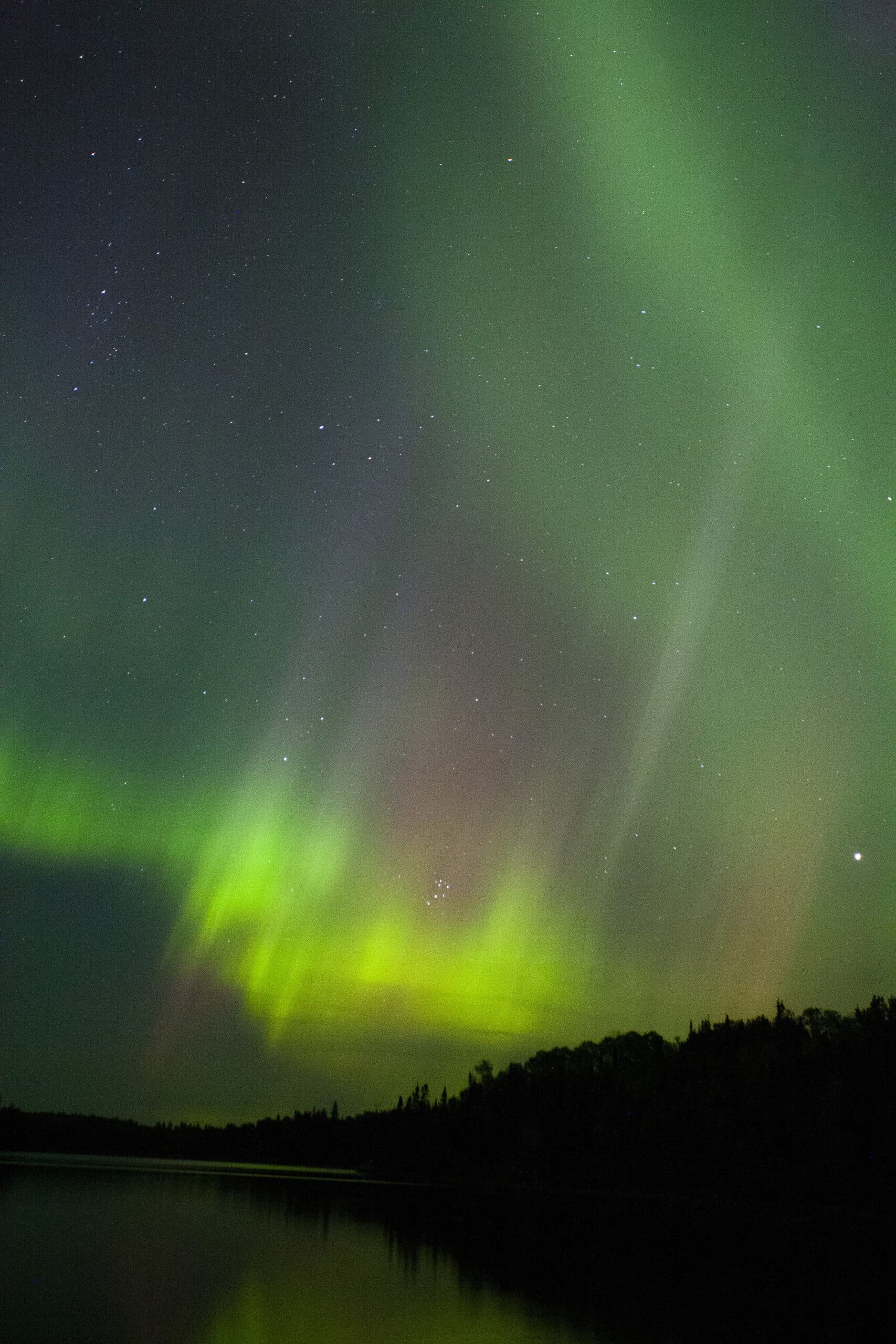 A bright Yellow, green, and purple aurora borealis display in Ontario.