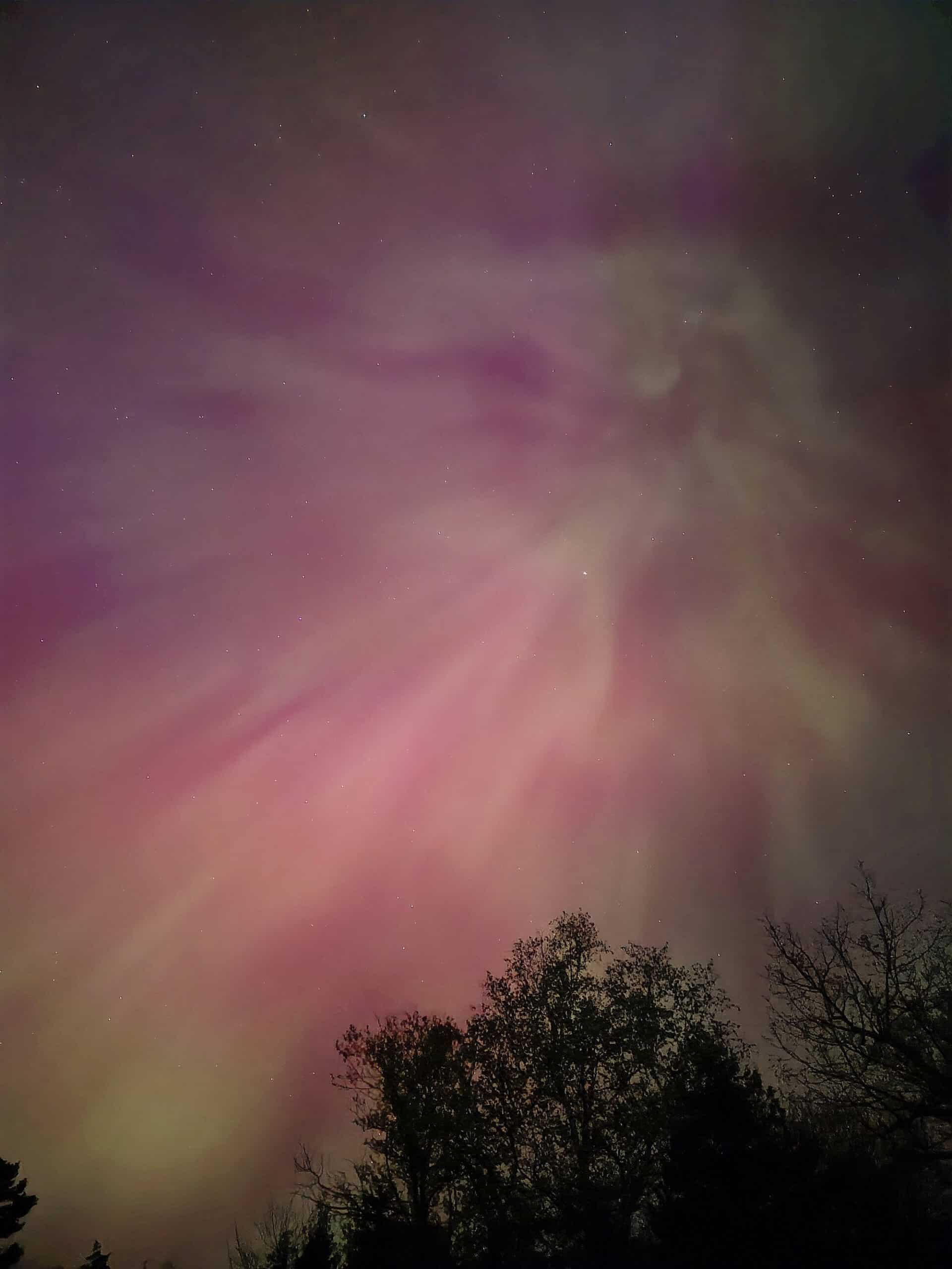 A bright pink aurora borealis display in Ontario.