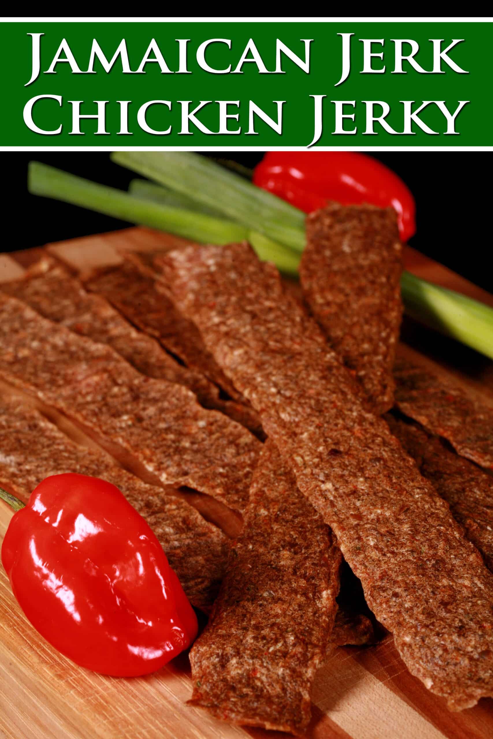 Several strips of chicken jerky on a cutting board, with green onions and scotch bonnet peppers. Overlaid text says jamaican jerk chicken jerky.