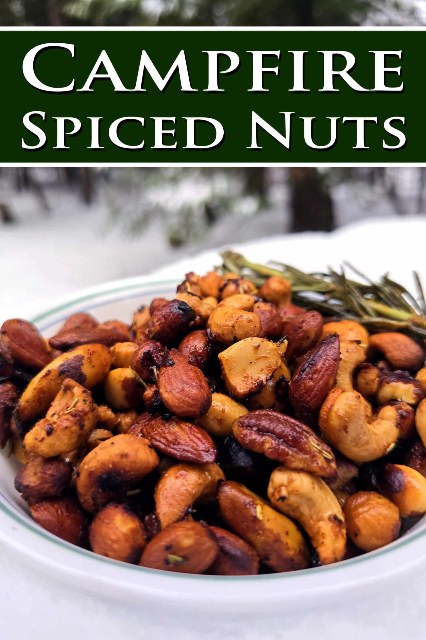 A bowl of fire roasted spicy rosemary nuts. Overlaid text says campfire spiced nuts.