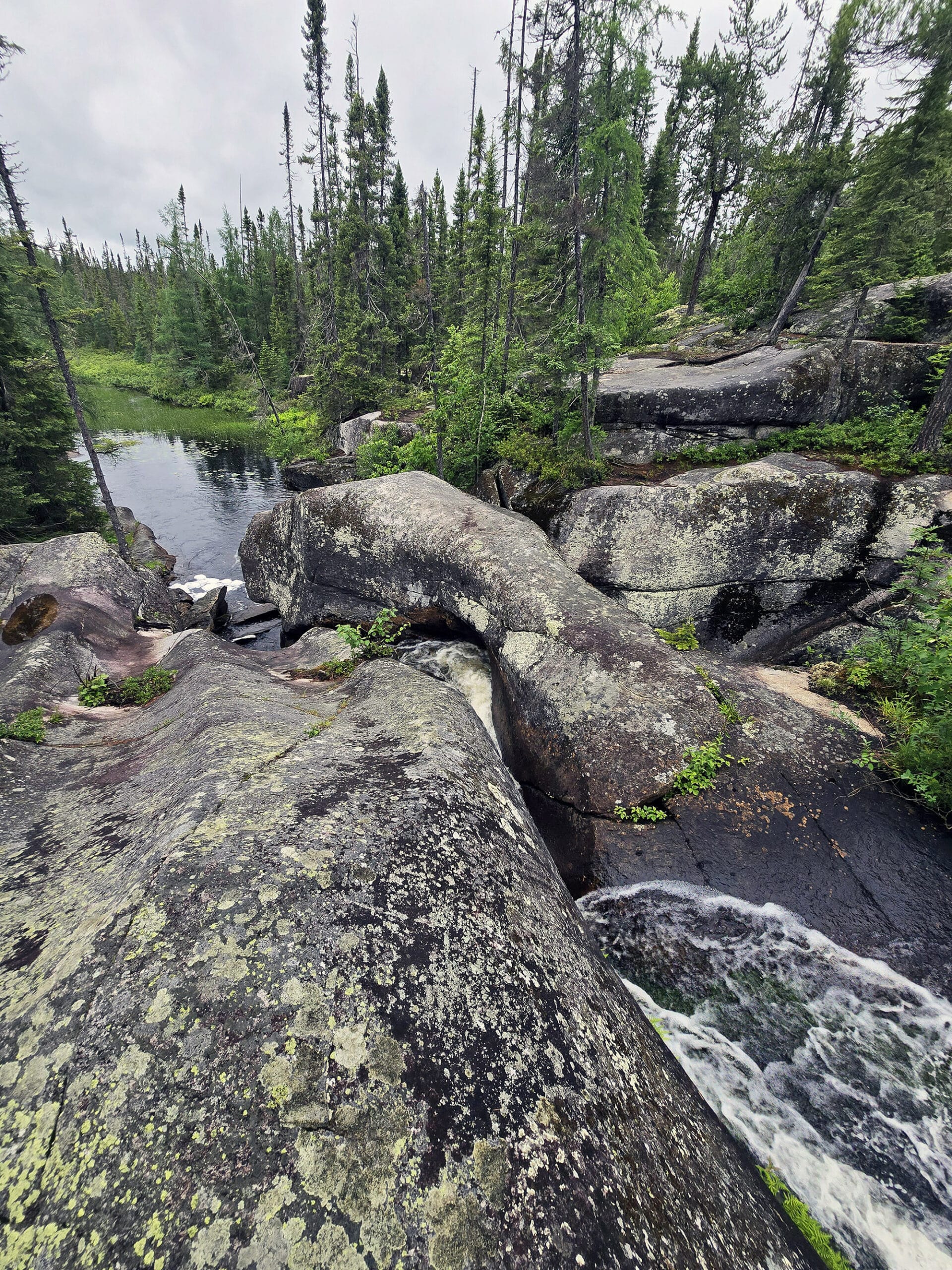 Several glacial potholes and curvy rocks at Potholes Provincial Park.