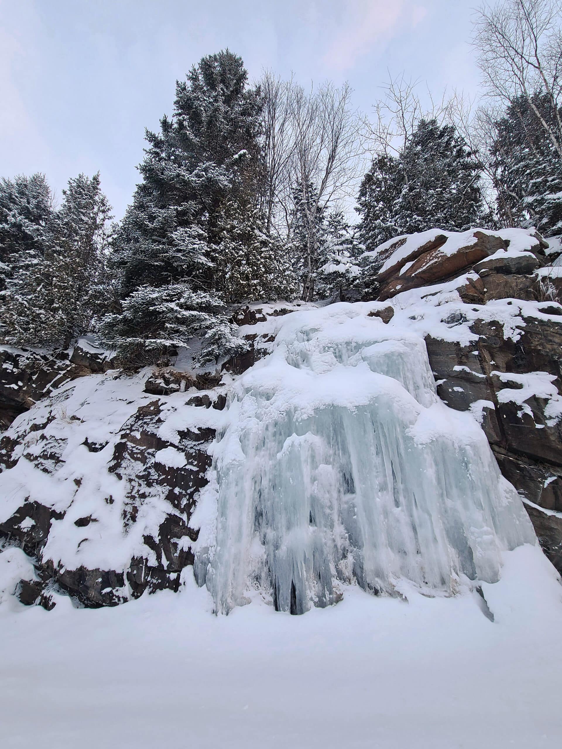 A rocky cliff with frozen ice waterfall along highway 60 in Algonquin Provincial Park.