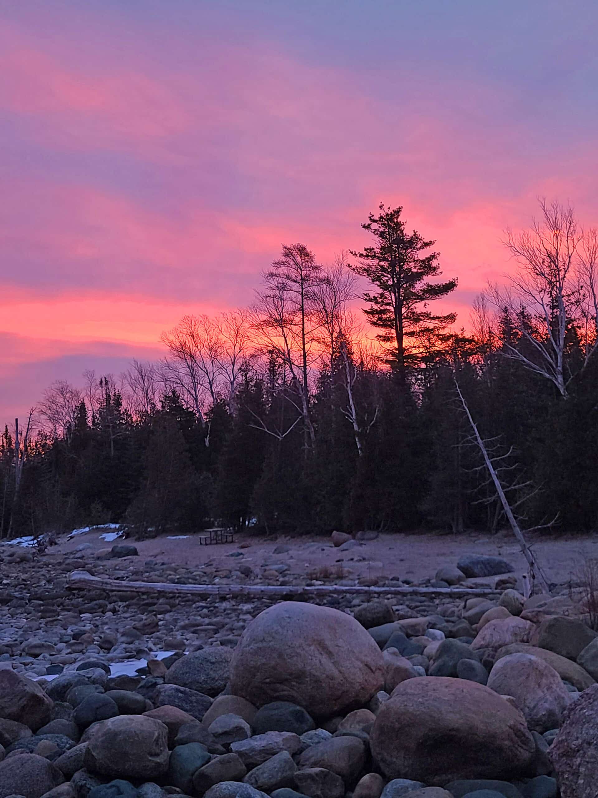 Sunrise over a snowy Lake Huron Beach.