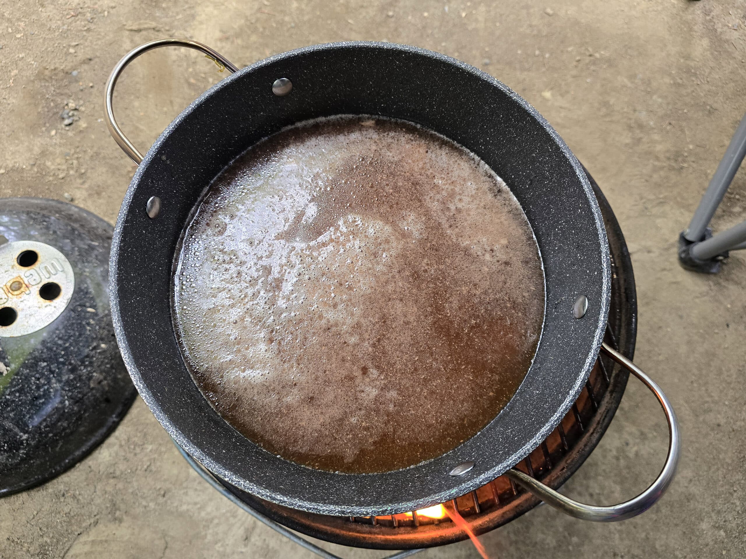 The pot of beef and broth at a low simmer.