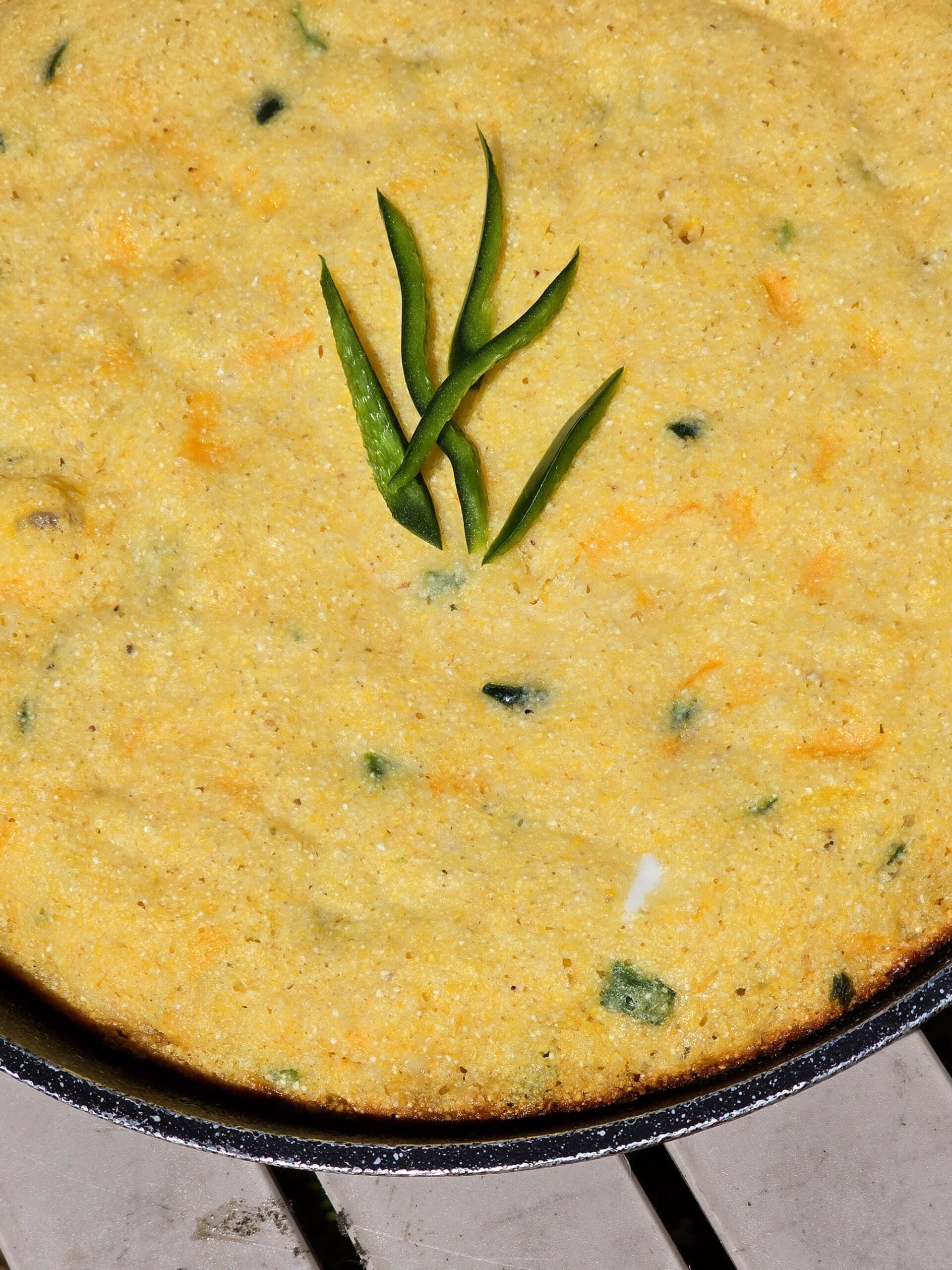 A pan of skillet cheddar jalapeno cornbread.