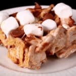 A no-bake smores bar made with golden grahams cereal, melted marshmallows, mini marshmallows, browned butter, and chocolate chips.