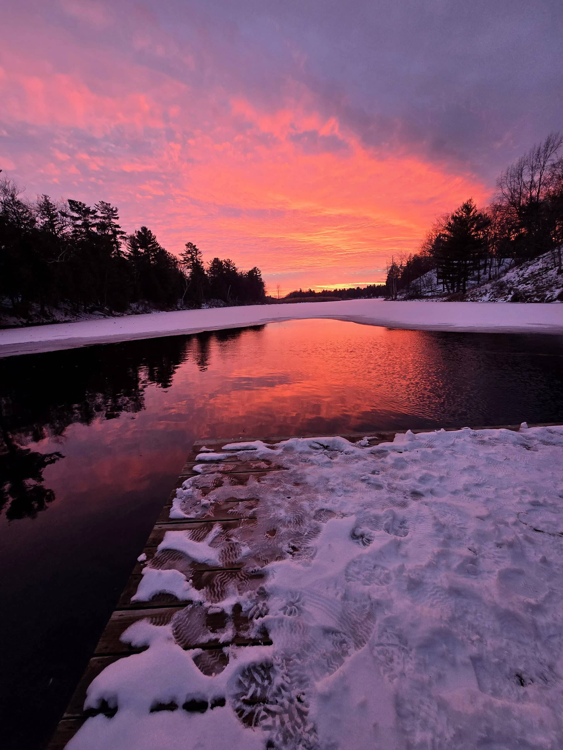 A bright pink sunset over old ausable channel in winter, at pinery provincial park.