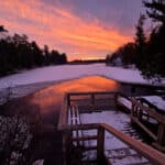 A bright pink sunset over old ausable channel in winter, at pinery provincial park.